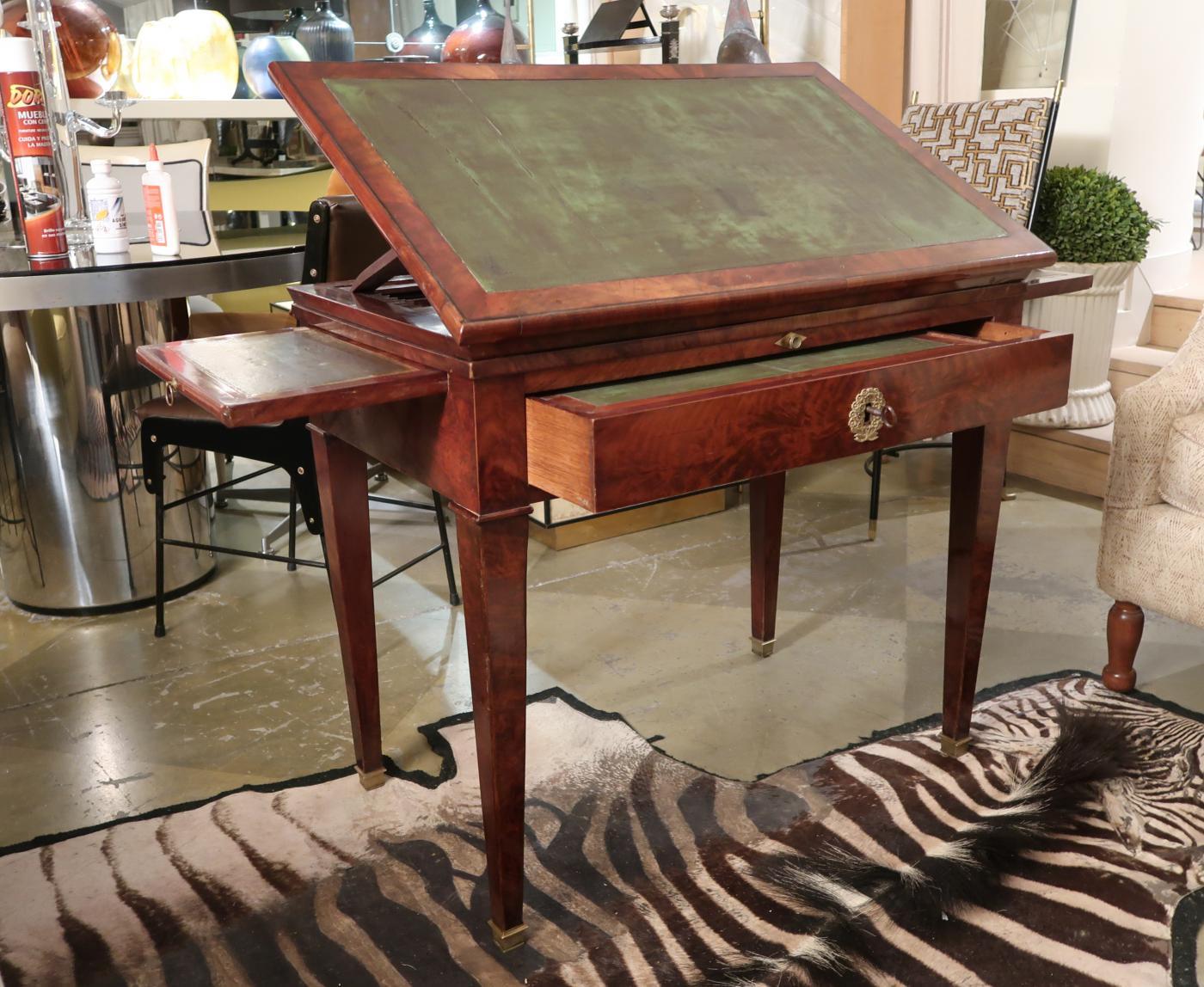 A mahogany and green leather neoclassical French work table, 19th century.