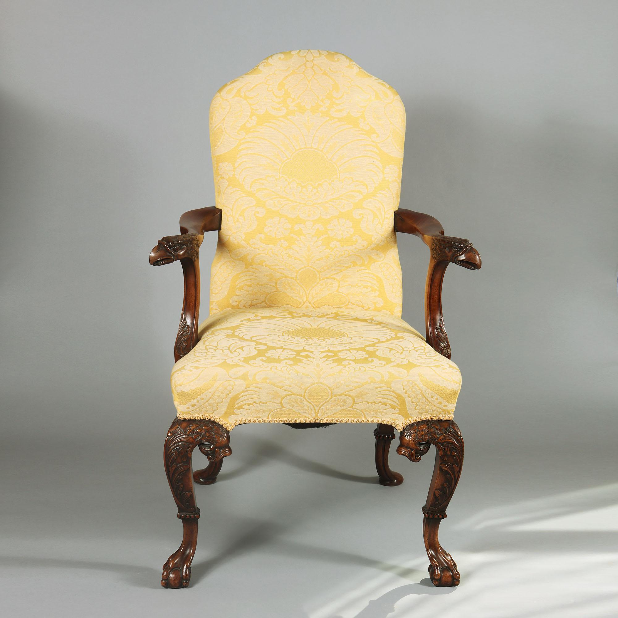 A mahogany open armchair in George I manner, with scroll carving of real style and panache having fine eagle head terminals to each arm, with distinctive scroll and feather work to the hipped cabriole legs above excellent collared ball and claw
