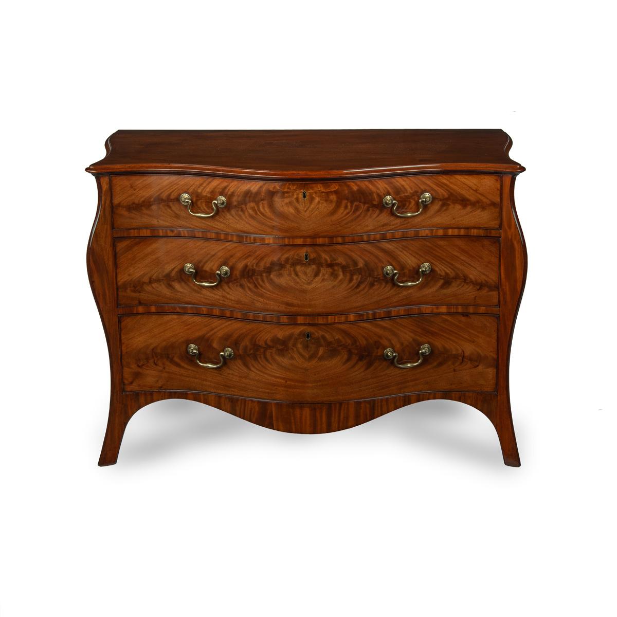 A mahogany three-drawer serpentine chest of drawers, attributed to Henry Hill, with three graduated drawers, originally with a fitted top drawer, now retaining the slide, decorated with flame book matched veneers.  English, circa 1770.

Published: