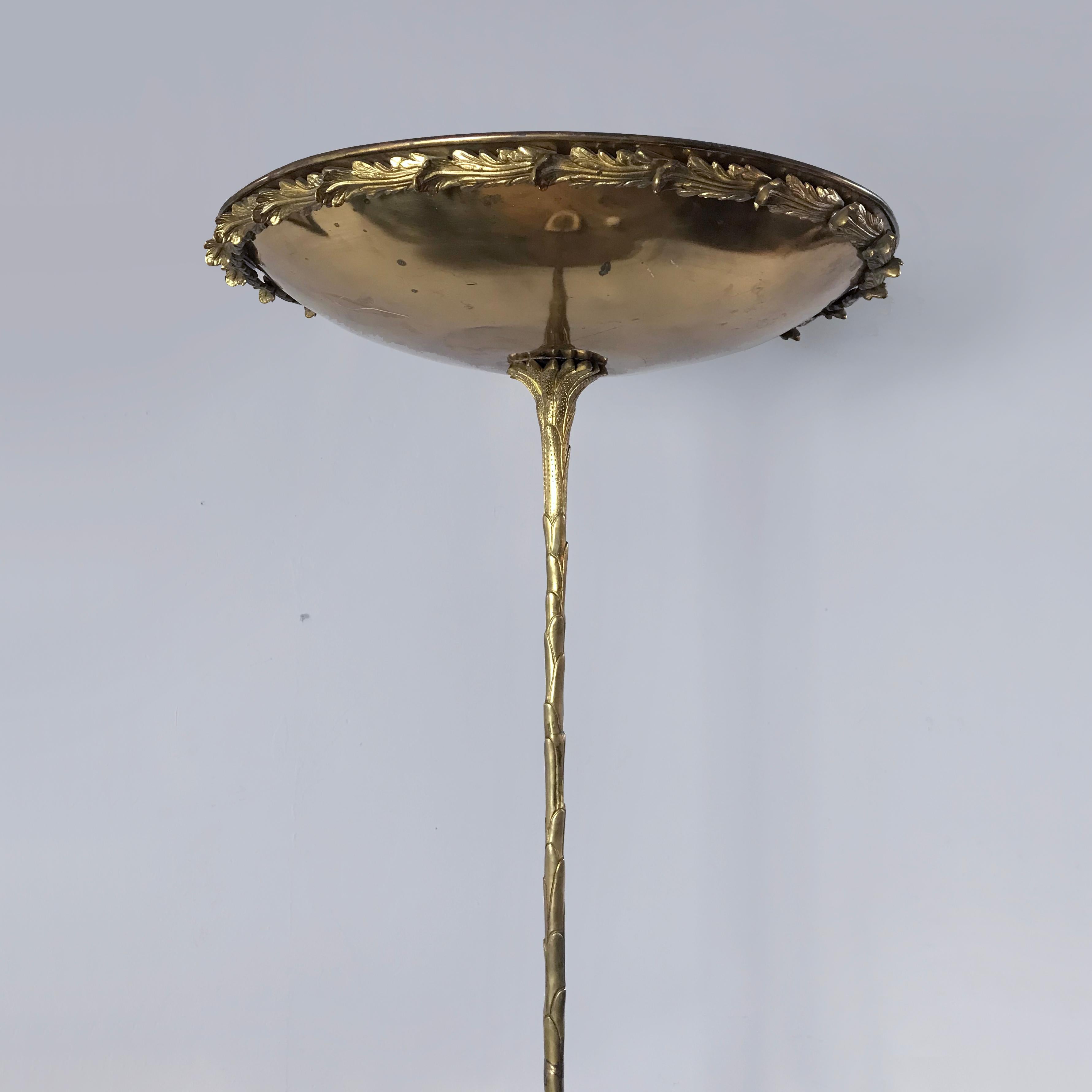 A very elegant gilt bronze Maison Bagues style uplighter.  The shallow brass dish mounted with gilt bronze leaf decoration. The slender palmette stem cast and chased sitting on a circular marble base mounted with further leaf decoration on gilt
