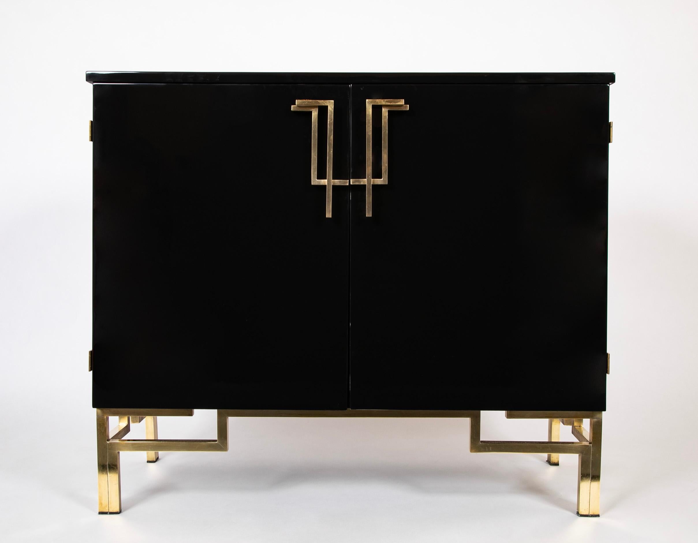A wonderfully pared down design by Guy Lefevre,  this piece represents a period during which Maison Jansen was shifting under Lefevres design leadership to a much more modern/ contemporary aesthetic circa 1970.   The black lacquer cabinet has