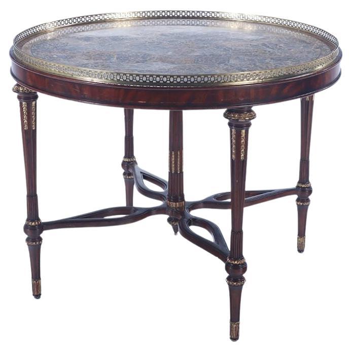 A Maitland smith crotch mahogany center table having a tessellated marble top For Sale