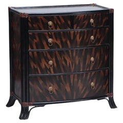 A  Maitland Smith ebonized five drawer bow front commode.