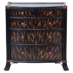 A  Maitland Smith ebonized five drawer bow front commode.