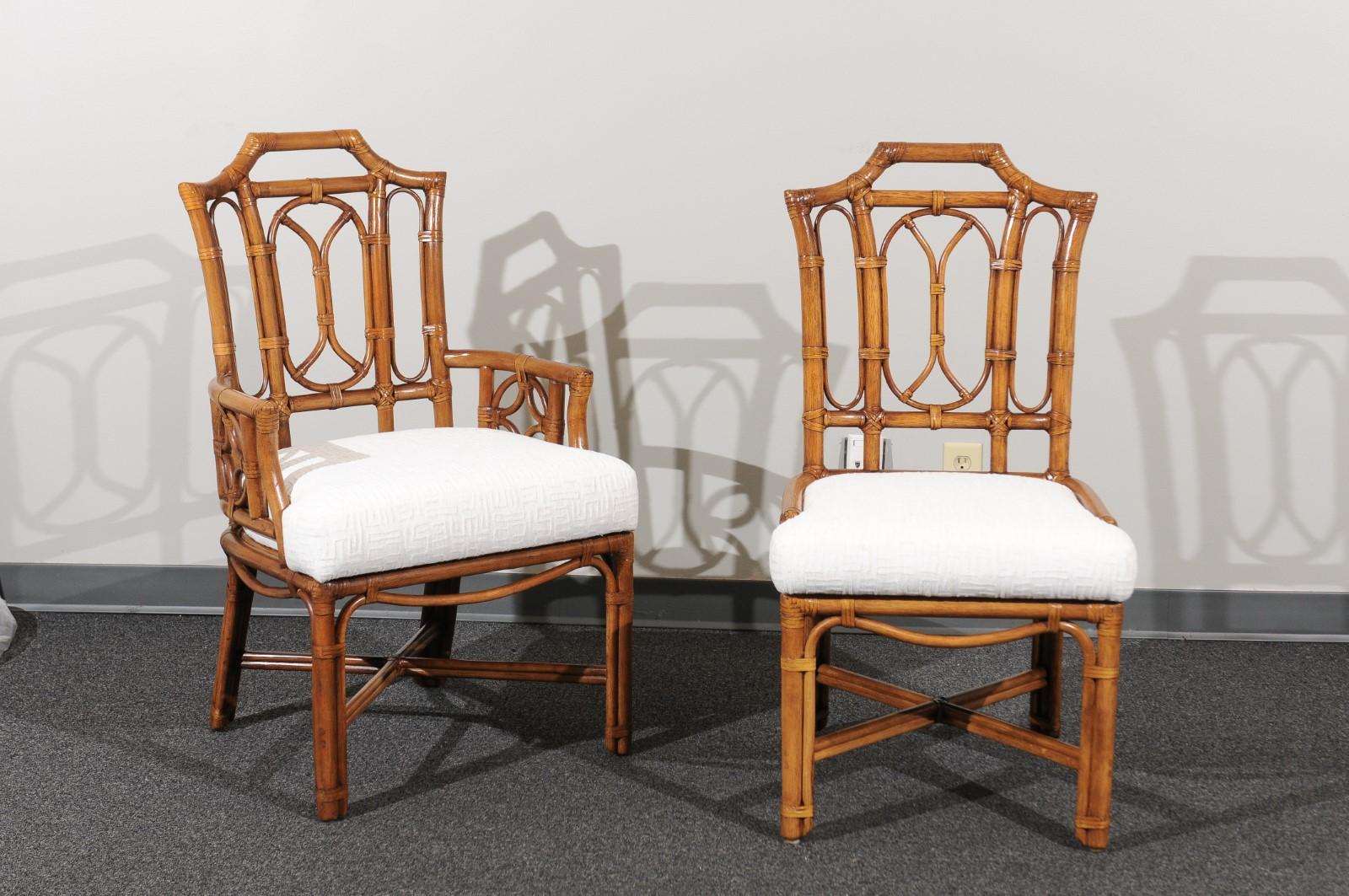 A radiant restored set of ten (10) dining chairs from a difficult to find series by Ficks Reed, circa 1980. There are two (2) host arm chairs and eight (8) side chairs. Stunning high back form with a fabulous Pagoda detail at the crest of the back.