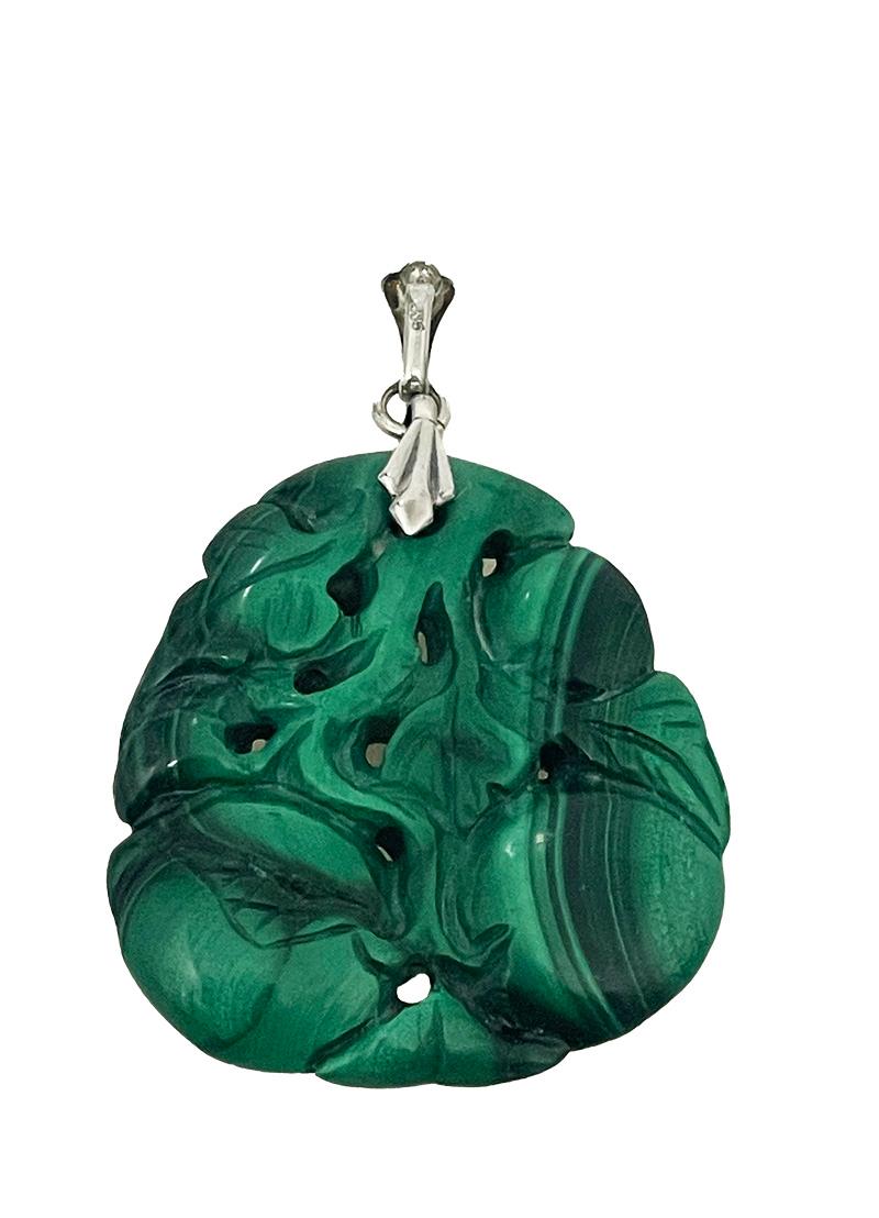 A Malachite pendant

A malachite pendant with silver eylet (835/000) with a scene of a cameleon in a tree with fruits and leaves. A hand-carved piece of malachite. 
The measurement is 5 cm high (total) 4 cm high just the malachite. 3.5 cm wide and