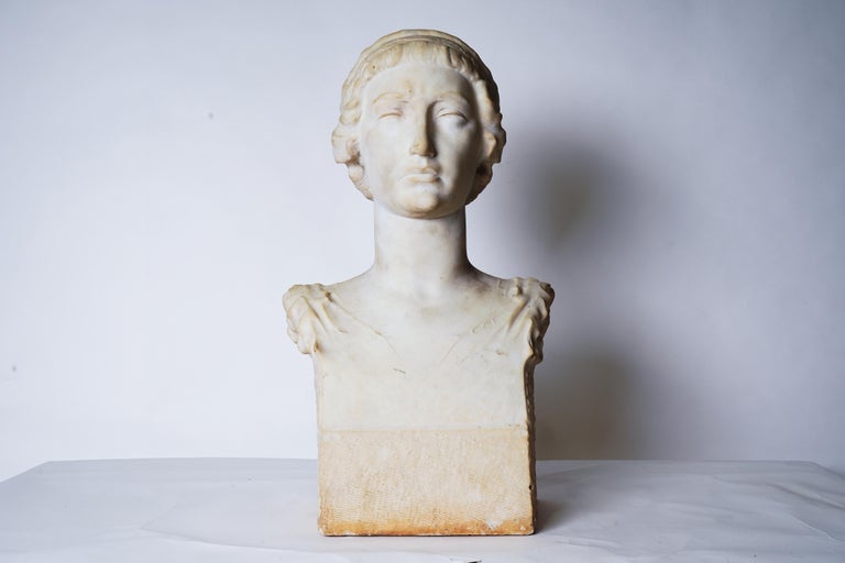 This elegant bust dates to the early 1900's and depicts a woman with classical features and a serene expression. The bust is from Barcelona, sculpted by Francec Madurell and dates to the early 1900's. Though the bust probably represents a specific