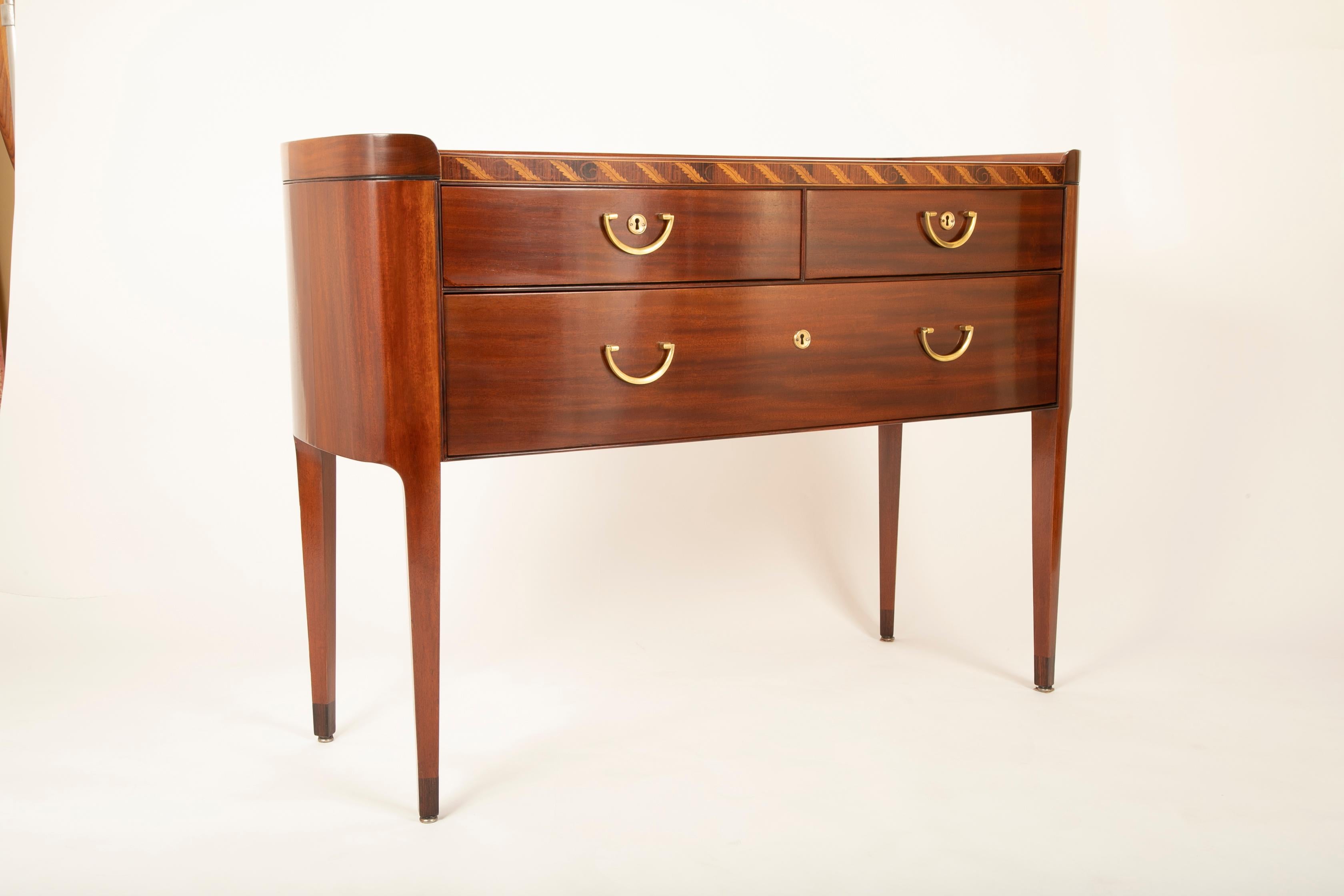 A Mahogany Sideboard with inset marble top designed by Paolo Buffa.   Having a foliate inlaid frieze above 3 drawers.   Italy Circa late 1930's 