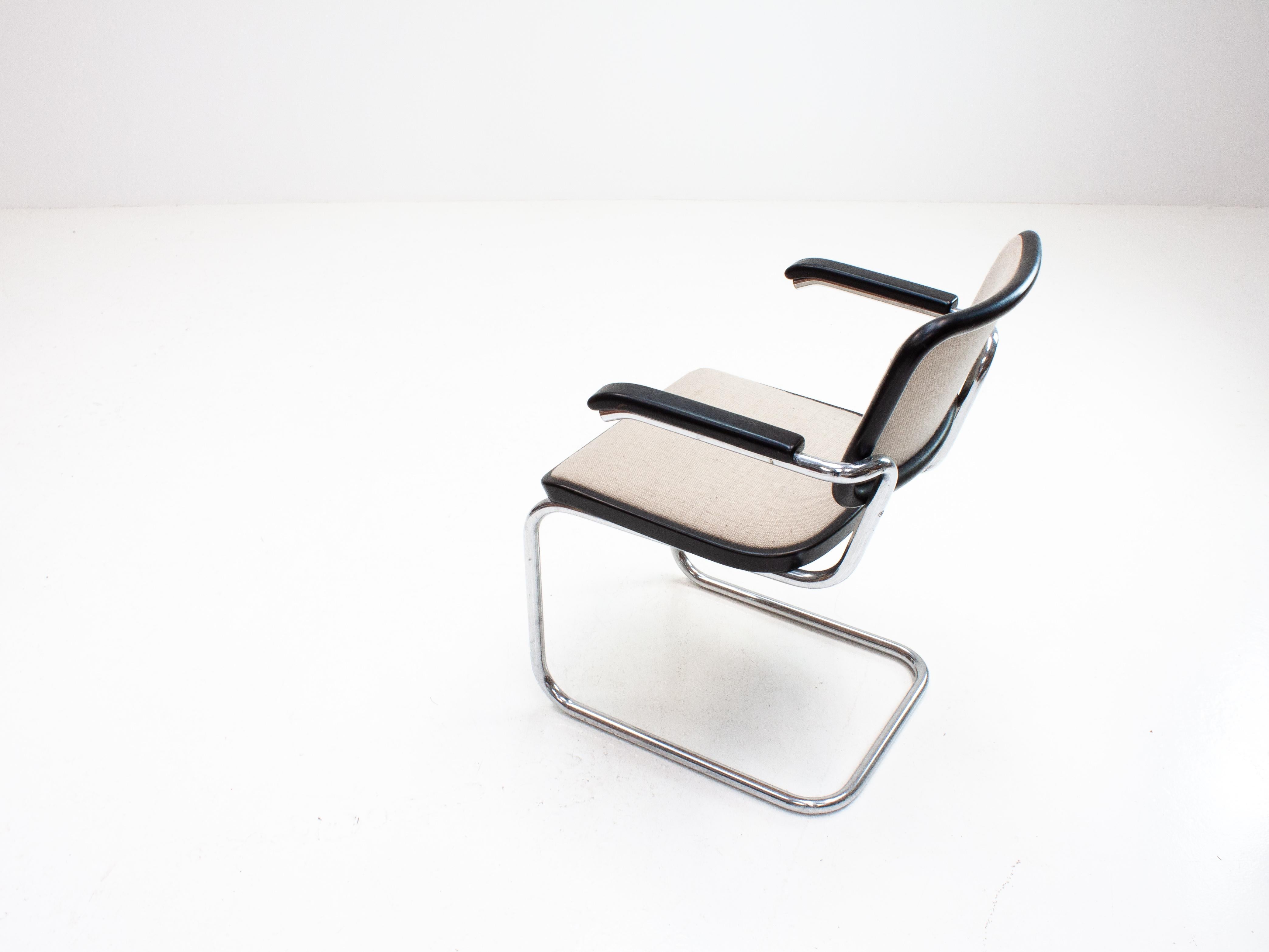 Marcel Breuer was a Hungarian-born modernist, architect and furniture designer.
 
This is one of his most iconic designs, the S64 consisting of a cantilevered tubular steel frame, black lacquered wood and material upholstery and this original