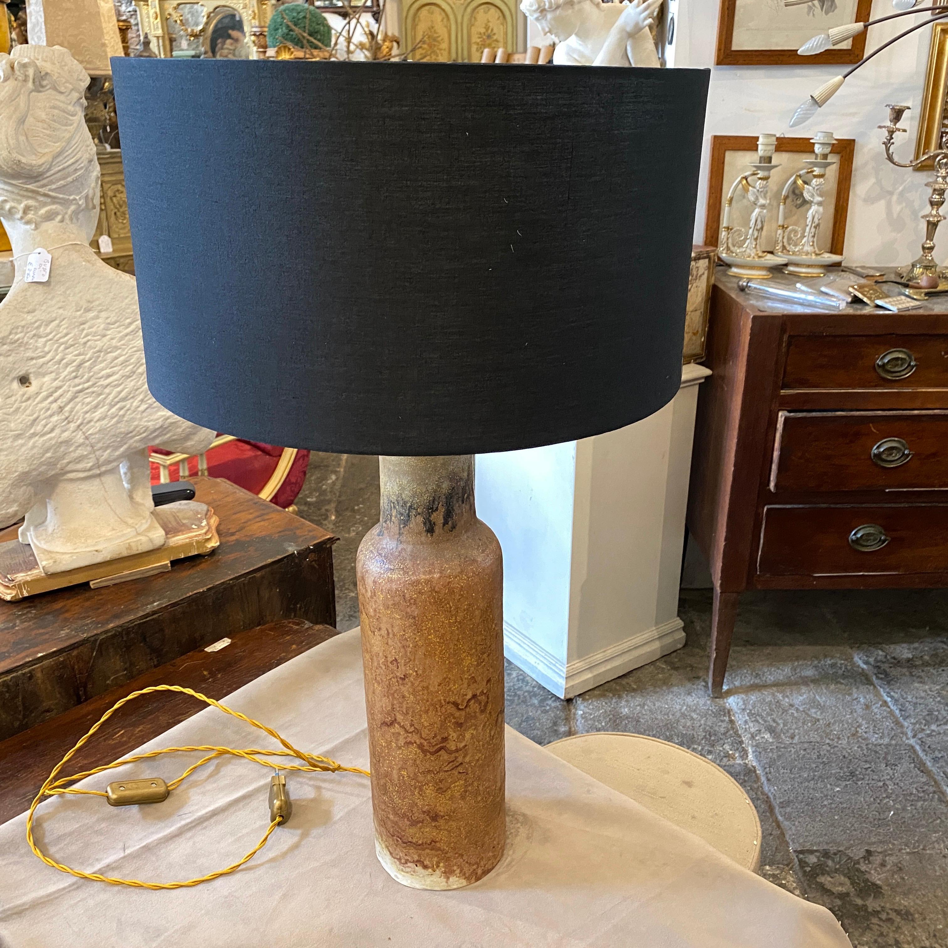 A particular ceramic table lamp by Marcello Fantoni in perfect conditions, it's signed in the bottom Fantoni.
Dimensions without lampshade, height cm 58 diameter cm 13. Fully restored electrical parts, it works 110-240 volts and needs a regular e27