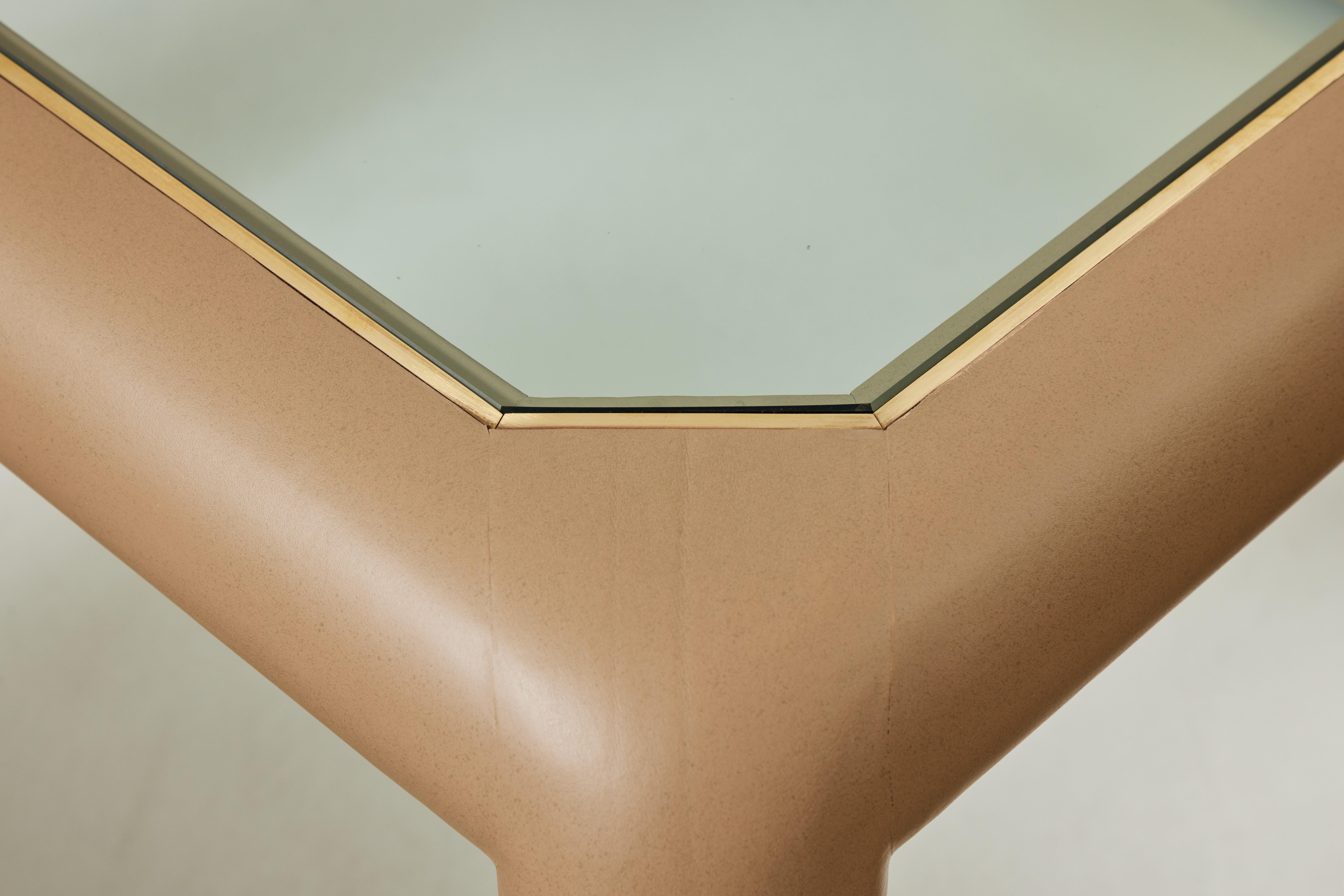 This is an original Mark II Game table by Karl Springer. It is covered in the original brownish taupe leather with an inset glass top. The four chairs are in the original matching leather with polished brass bases and casters. Chairs measure 25.5