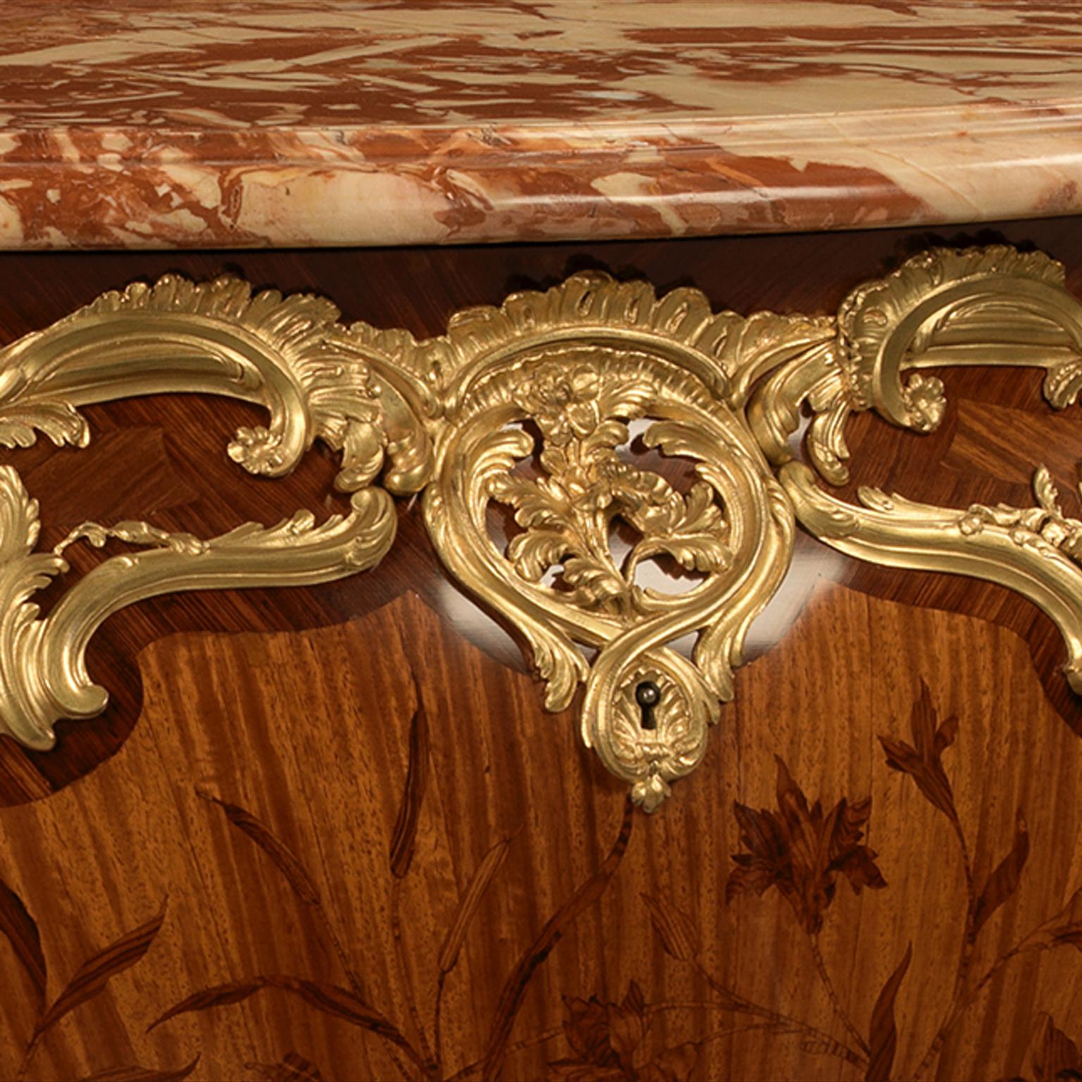 A Very Fine Marble Top Marquetry and Gilt-Bronze Commode by Emmanuel Zwiener.

The keyhole escutcheon stamped with the ‘ZN’ mark from the bronze master model.  The back of the bronzes stamped ‘NZ’.

This exceptional commode has a brèche de