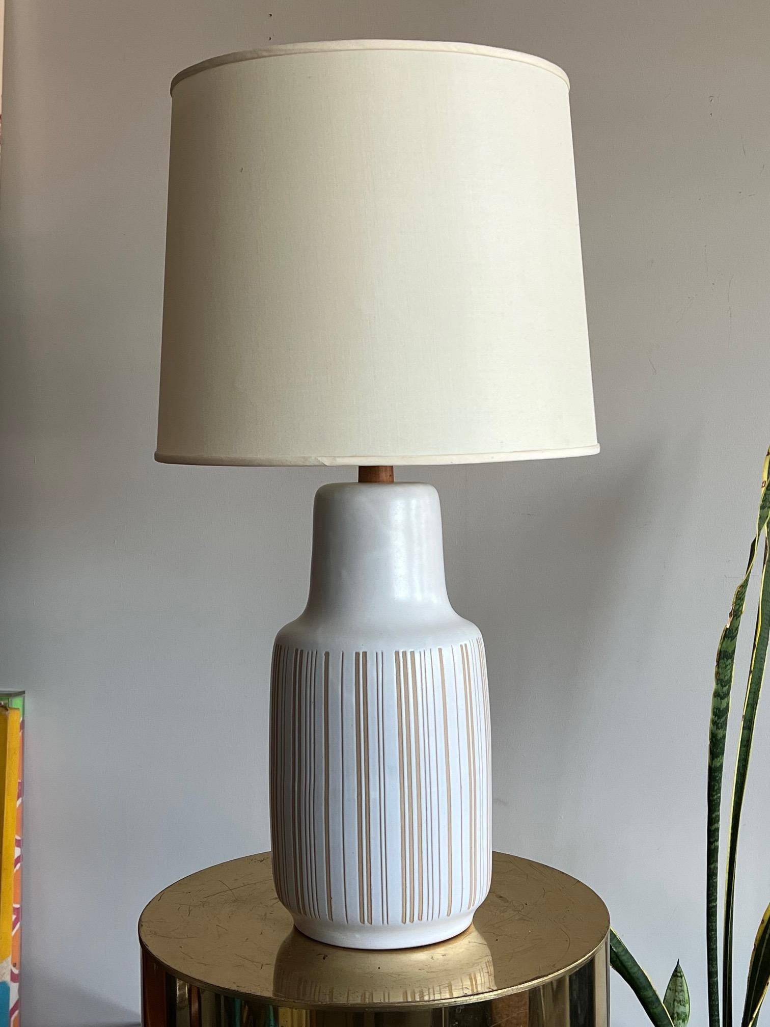 An elegant, large scale Martz lamp with vertical line decoration. Teak neck, electrified with a three way switch.