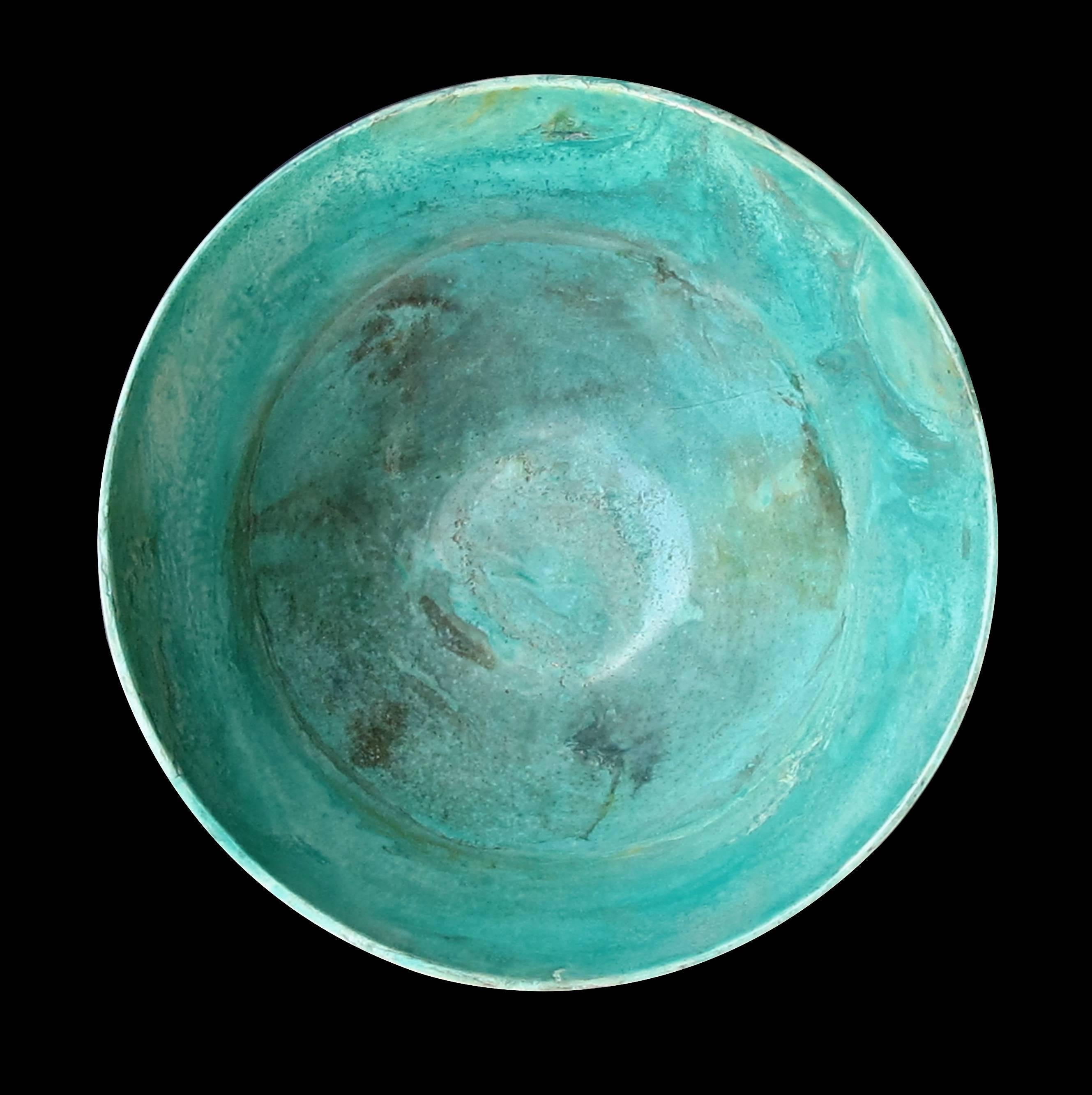 The unusually large bowl with deep sides carved from the chrysocolla mineral with its vibrant teal color because of its high copper content; in a honed finish; a true statement piece as a centrepiece; signed and dated 2003.