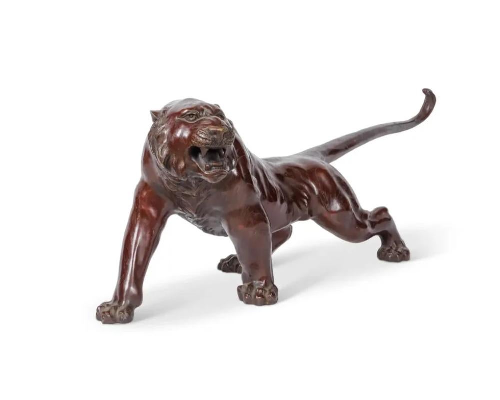 A Massive Japanese Patinated Bronze Sculpture of a Tiger, Meiji Period. Signed.
 
Measuring an impressive 44 inches in length, this extraordinary sculpture is a striking example of the grandeur and craftsmanship characteristic of the Meiji era