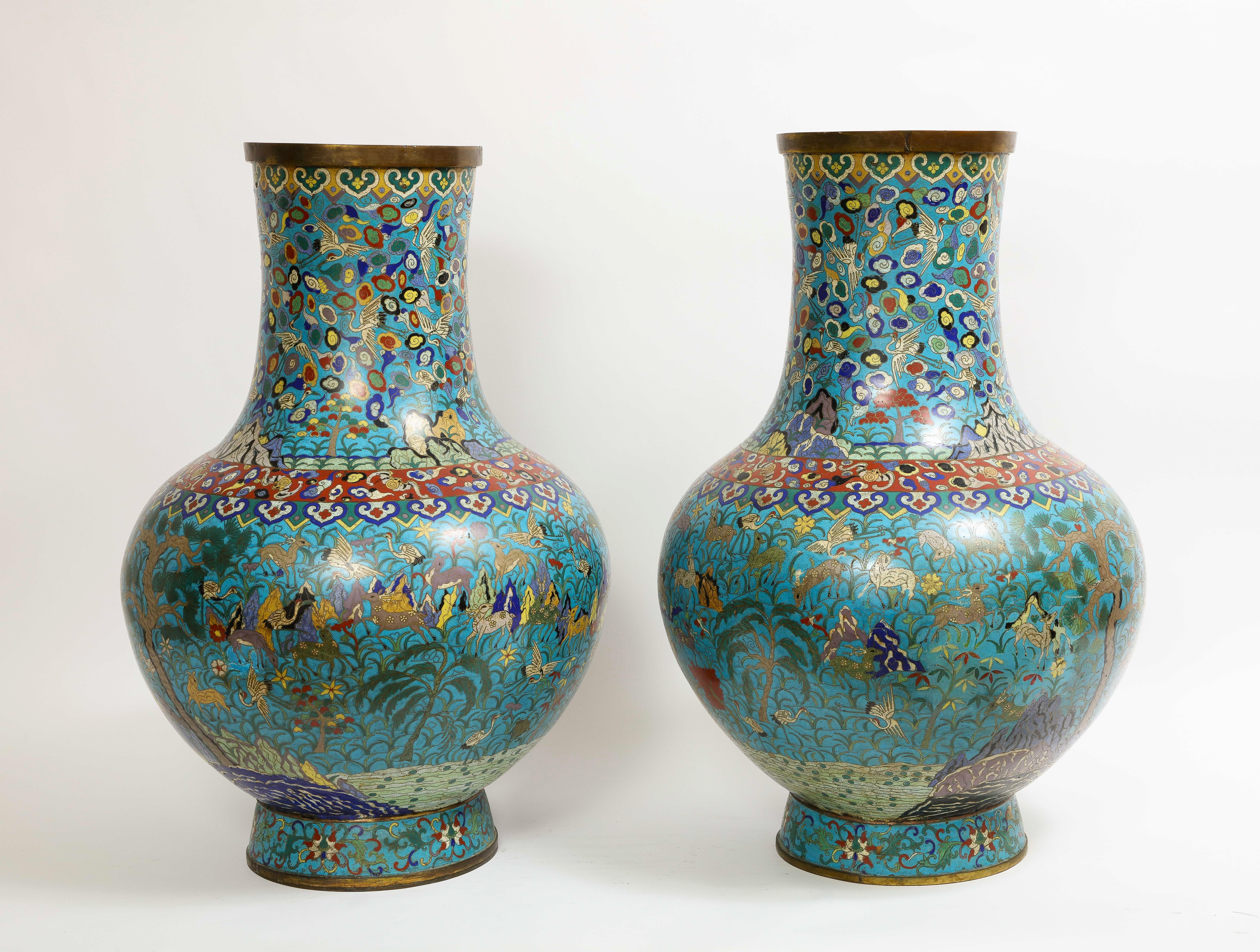 A massive and impressive Pair of 19th C. Chinese Cloisonne Enamel Vases with '100' Deer Decoration. Decorated with a multitude of deer and birds amongst a meadow with flowering branches growing from rocks and mountains on a turquoise ground. The