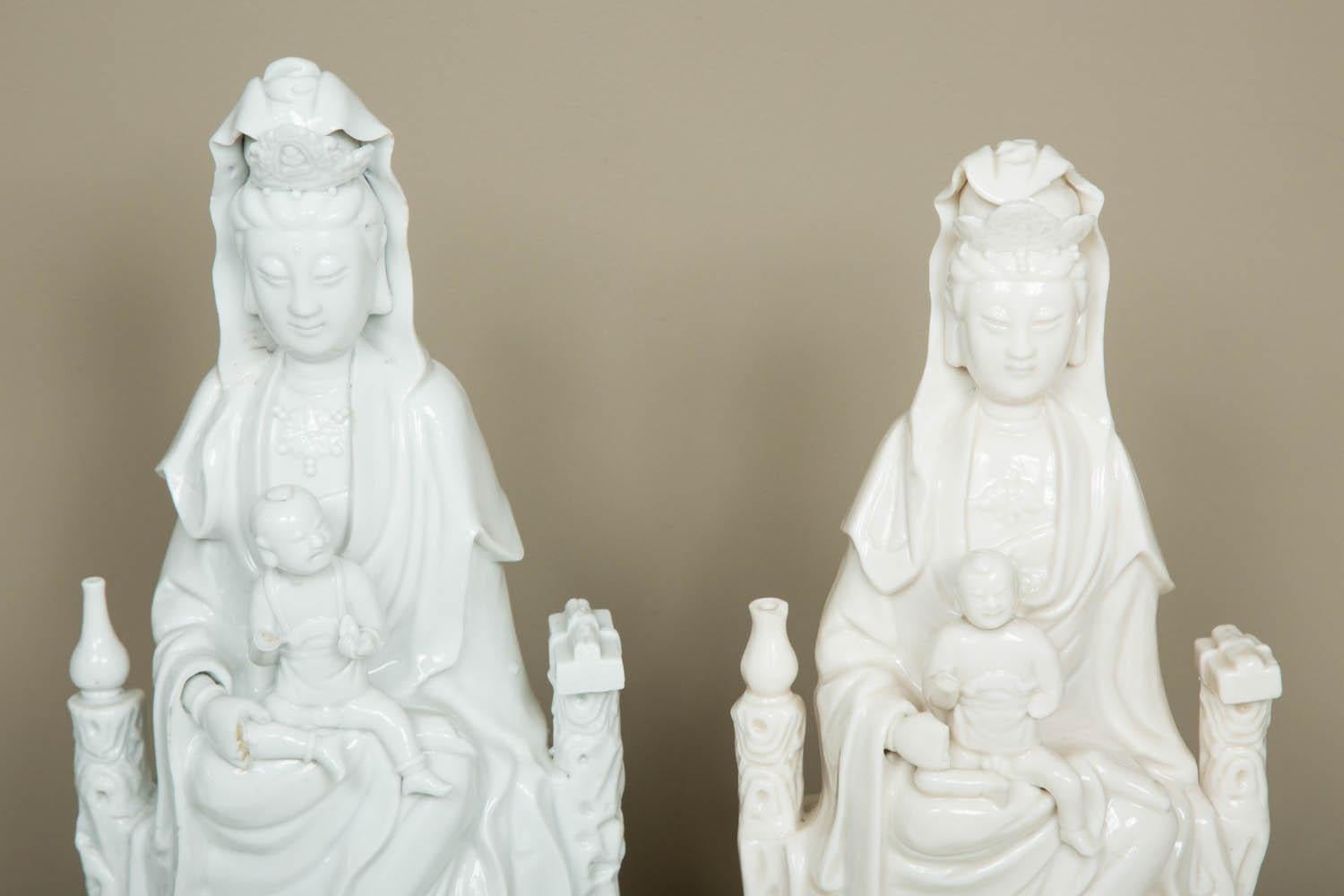 A Kangxi period (1662-1722) matched pair of Blanc de Chine porcelain model of seated Guanyin in the most popular representation: holding a child, flanked by two children bearing offers;
from the kilns in Dehua, Fujian Province.
Condition: as per