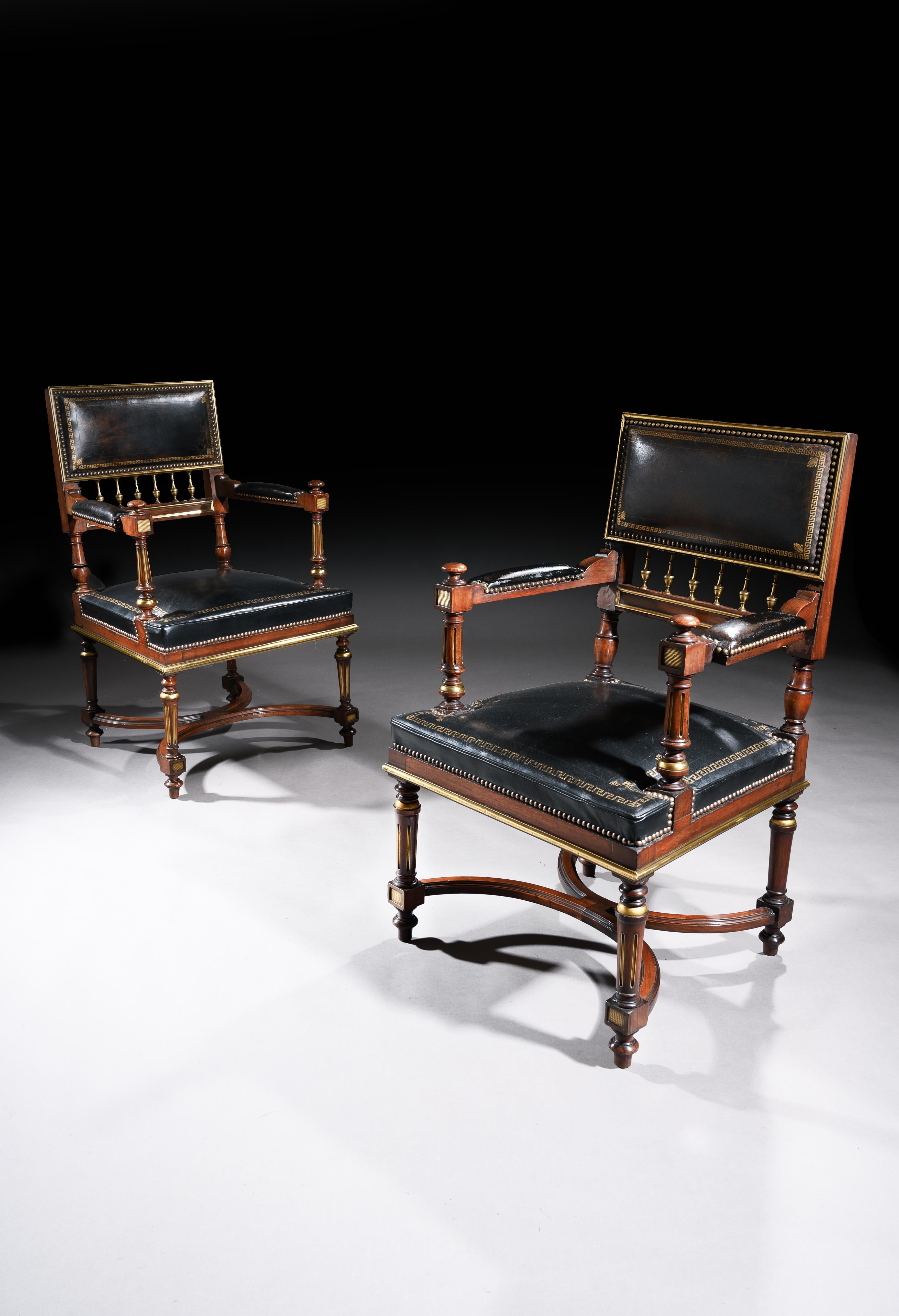 A matched pair of late 19th century French brass mounted walnut leathered open armchairs or desk chairs.

French, circa 1870.

Dating to the Napoleon III period, the design of the chairs are in the Empire manner, often referred to as ‘Second