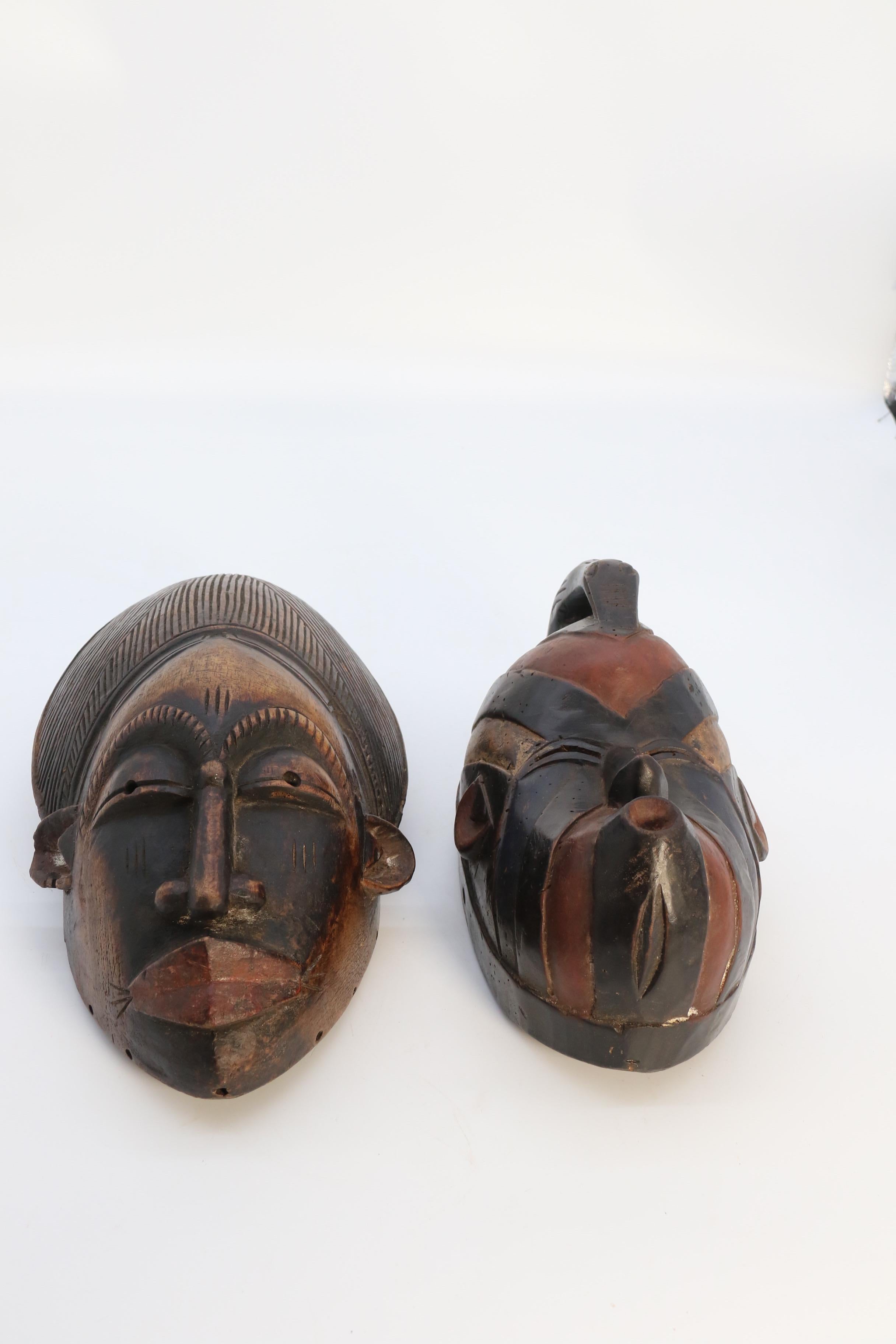 Wood A matched pair of African tribal dance face masks, circa 1920