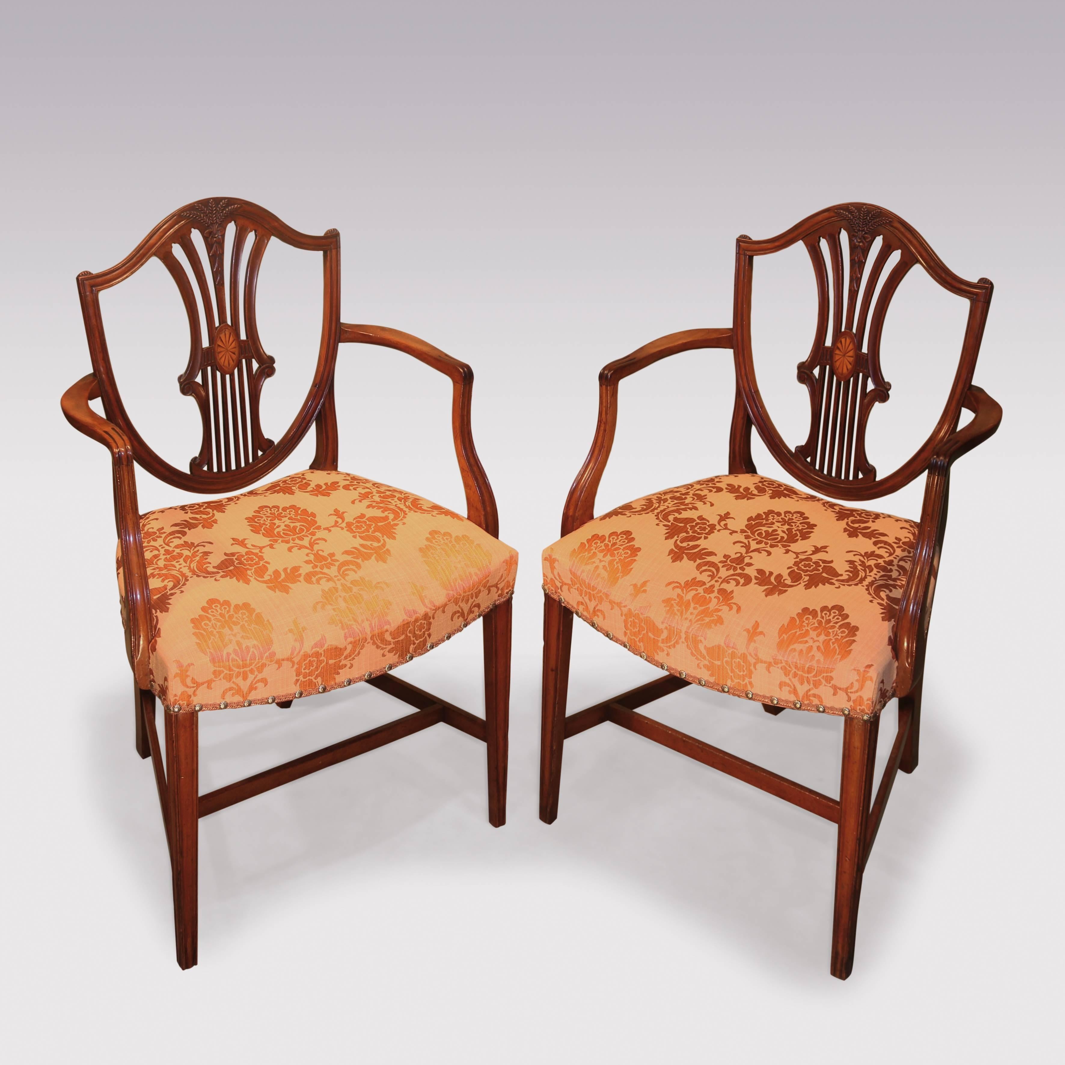 A matched set of eight single and two arm late 18th century Hepplewhite period mahogany dining chairs, having shield shaped backs with pierced slats, and wheat ear carving, above drop in seats supported on tapering legs.
The armchairs with boxwood