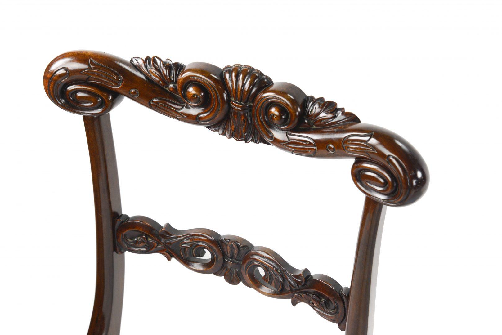 An exceptional set of eleven George IV rosewood dining chairs a set of eight plus three similar, heavily carved back rails, by Gillows of Lancaster. One of the chair rails is stamped on the underside with the word eight, presumably the number of