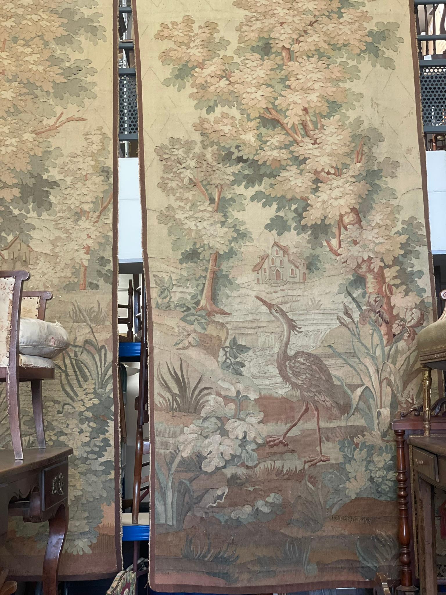 A captivating pair of fine and complementary Aubusson Verdure tapestries, of equal, large size, featuring scenes of wild birds (ducks and herons) amid typically Aubusson settings of lush rural countryside and romantic architecture. Woven in wool and