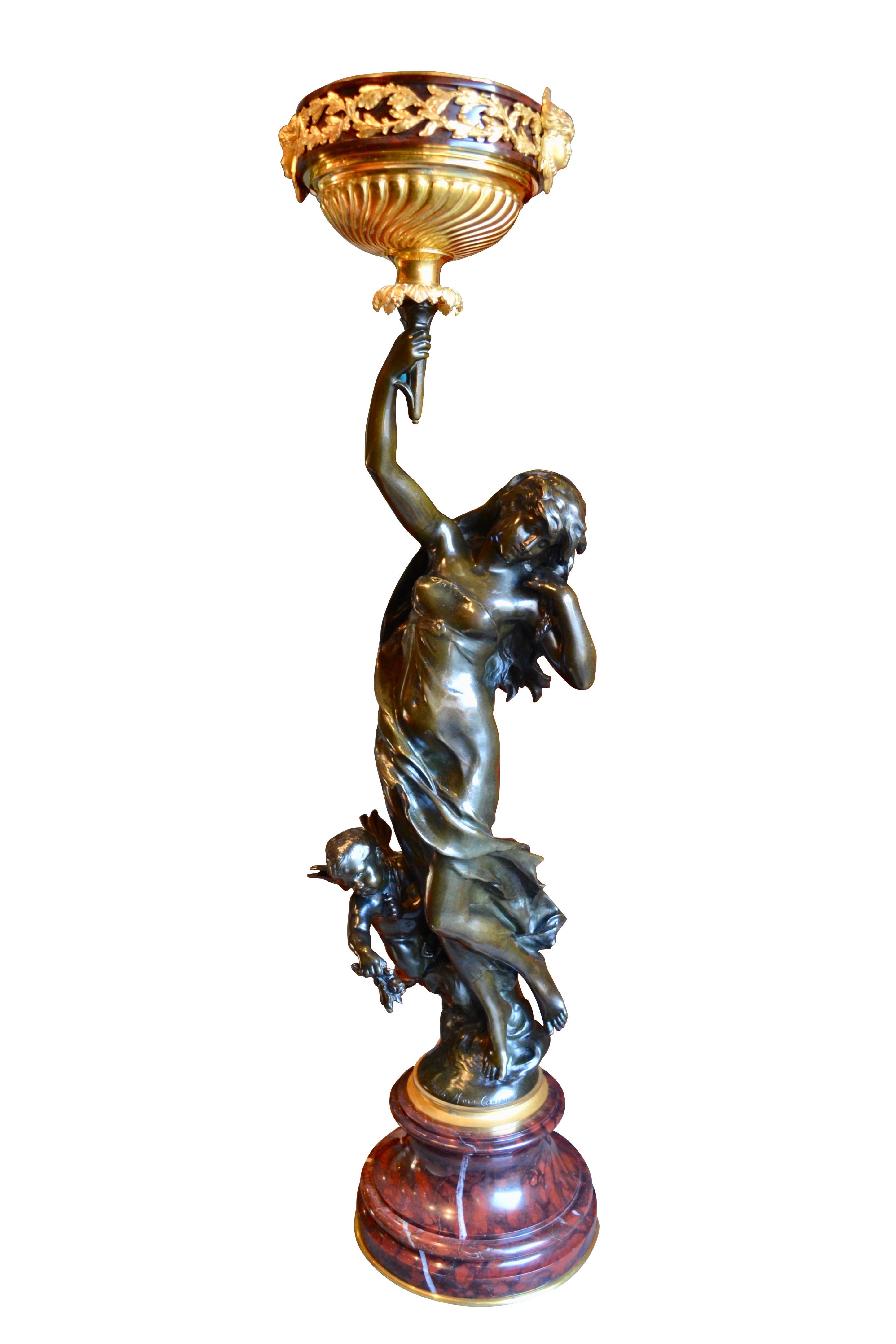 A rare  bronze statue of na Nymph and a clinging putto by famous French 19 Century sculptor  Mathurin Moreau which was custom transformed into an oil lamp. The nymph is is holding aloft a flambeau  which was part of the bronze by 
 Moreau to which