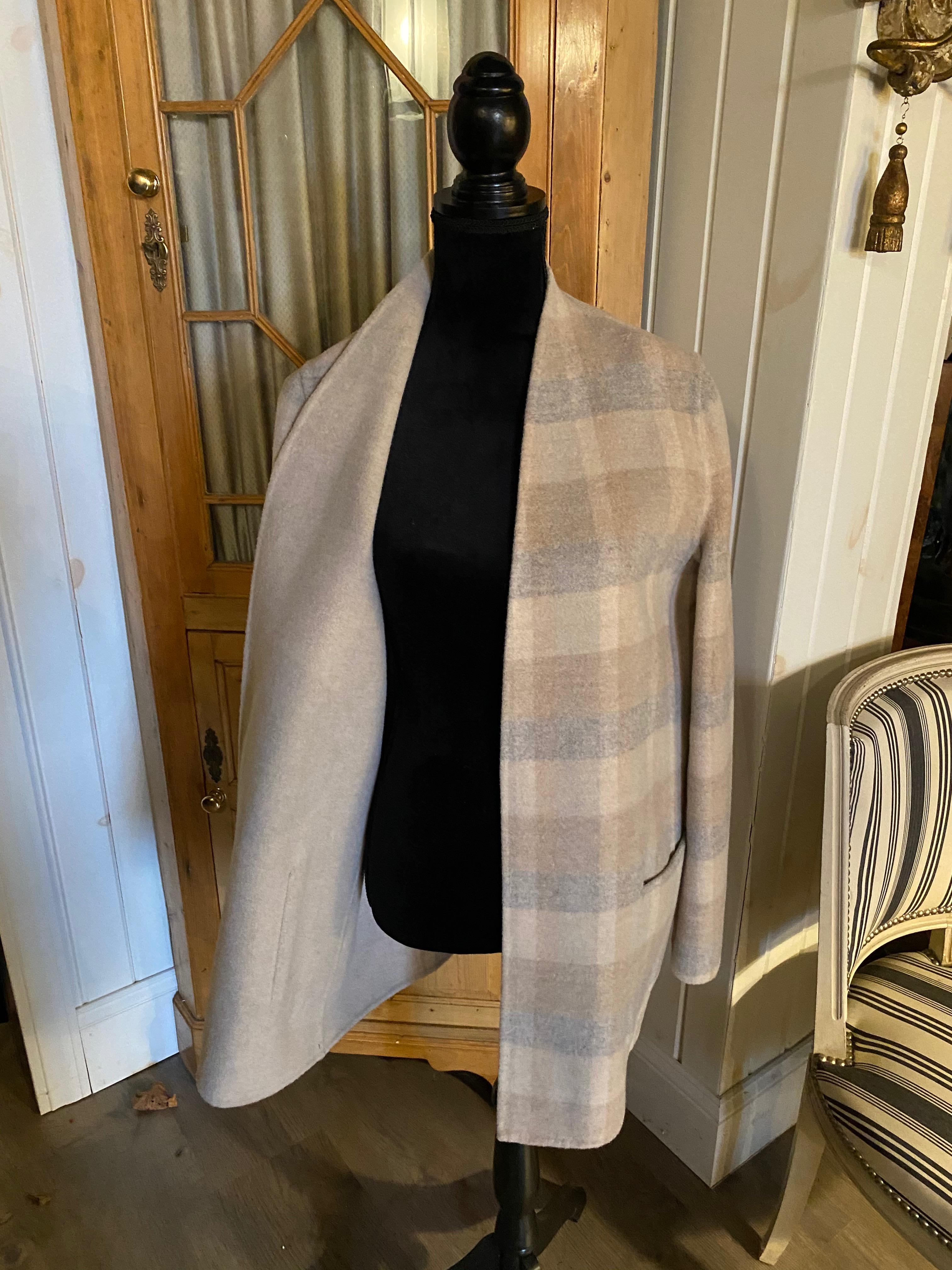 A MAX MARA DUSTER JACKET.

Wool and angora blend collarless coat with front patched pockets. Unlined. Label partially removed

Approximately a size 10-12