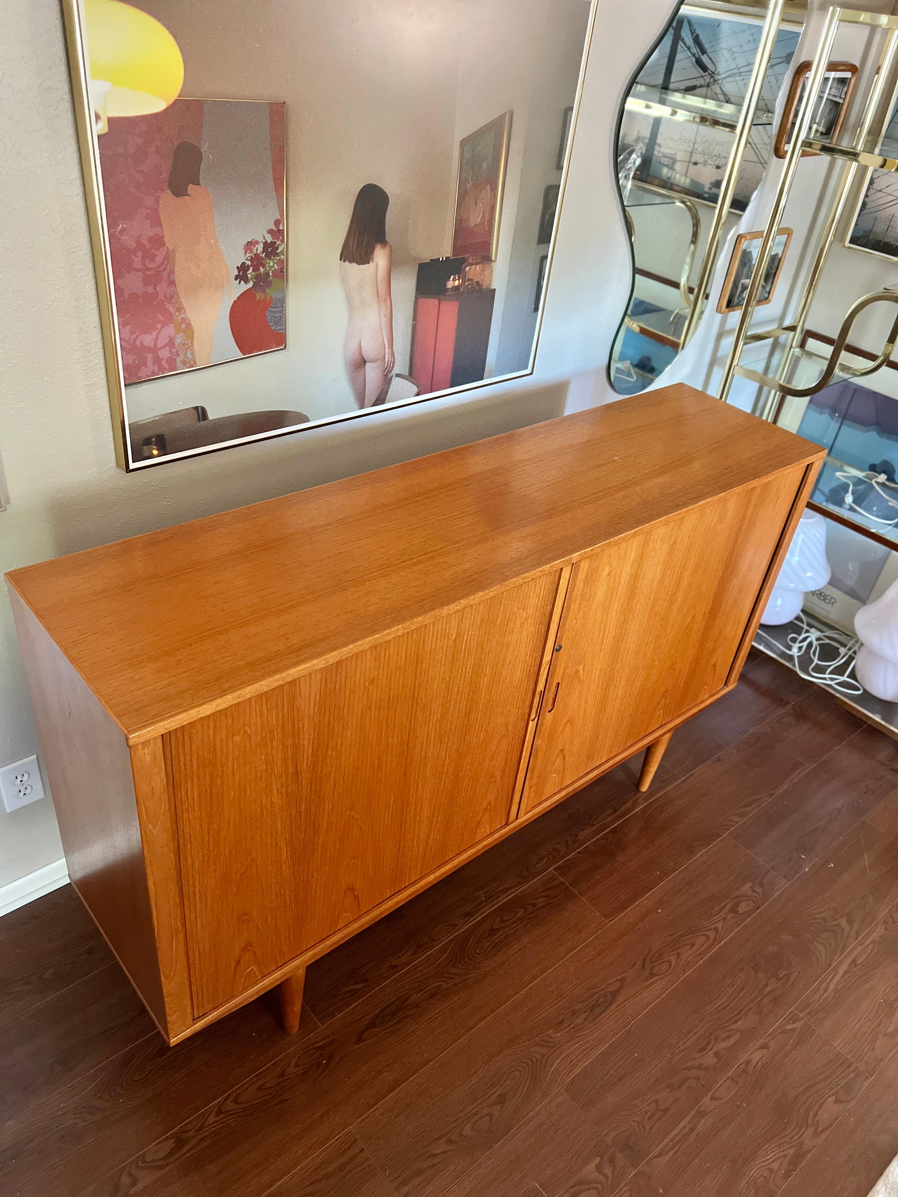 European A MCM minimalist teak tall sideboard with tambour doors and tapered legs