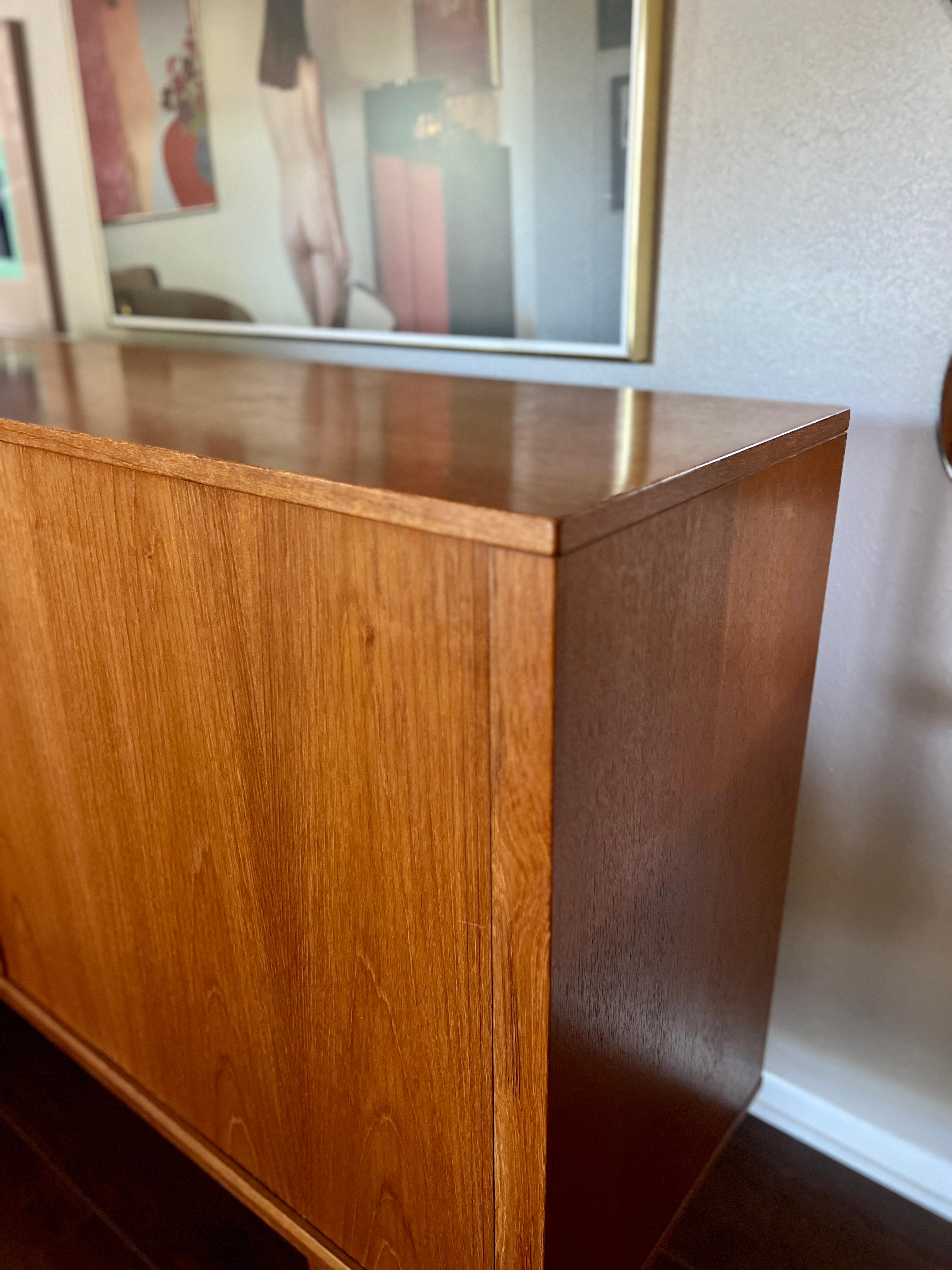 A MCM minimalist teak tall sideboard with tambour doors and tapered legs 2
