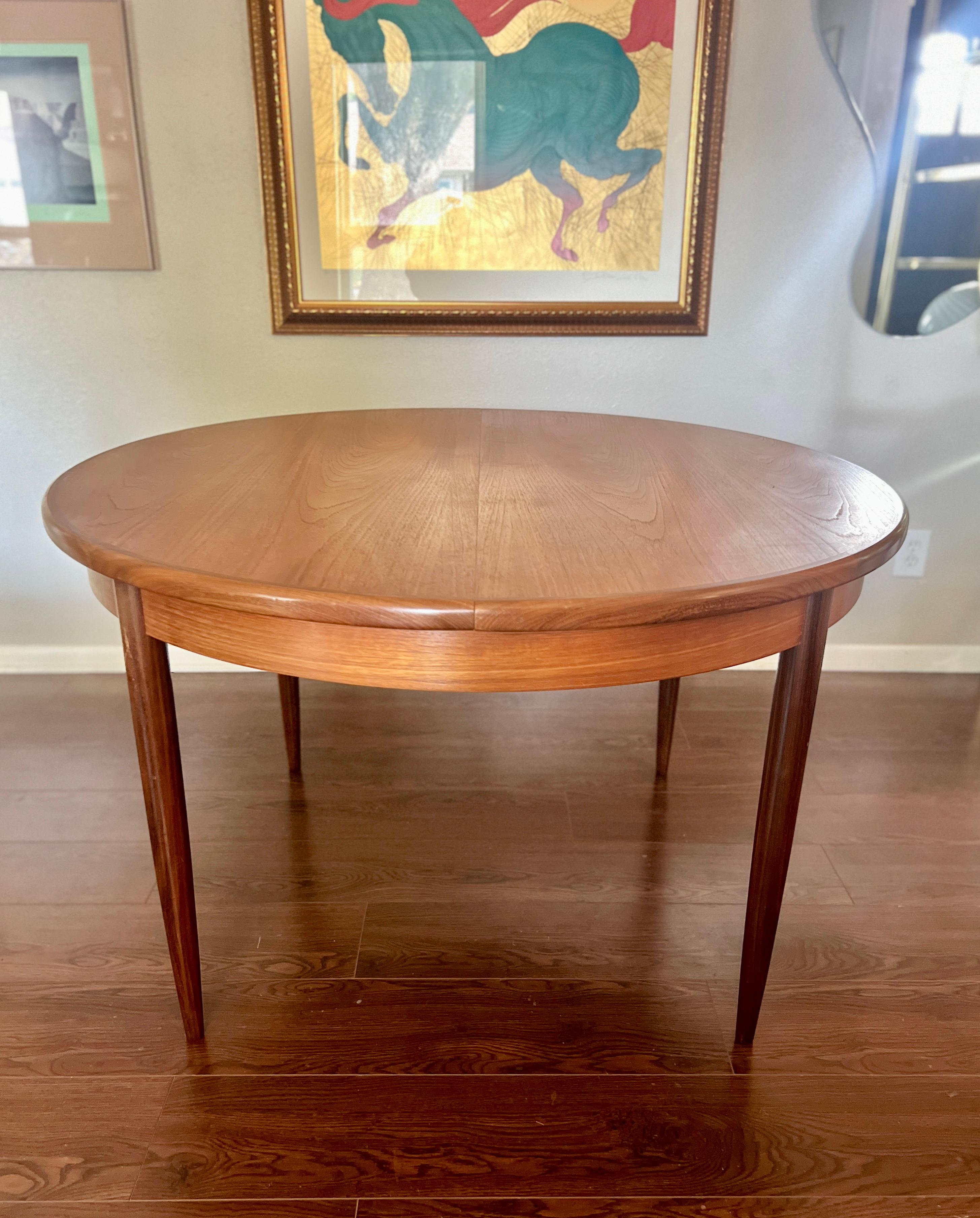 European A MCM round teak dining table by G plan, with one 18