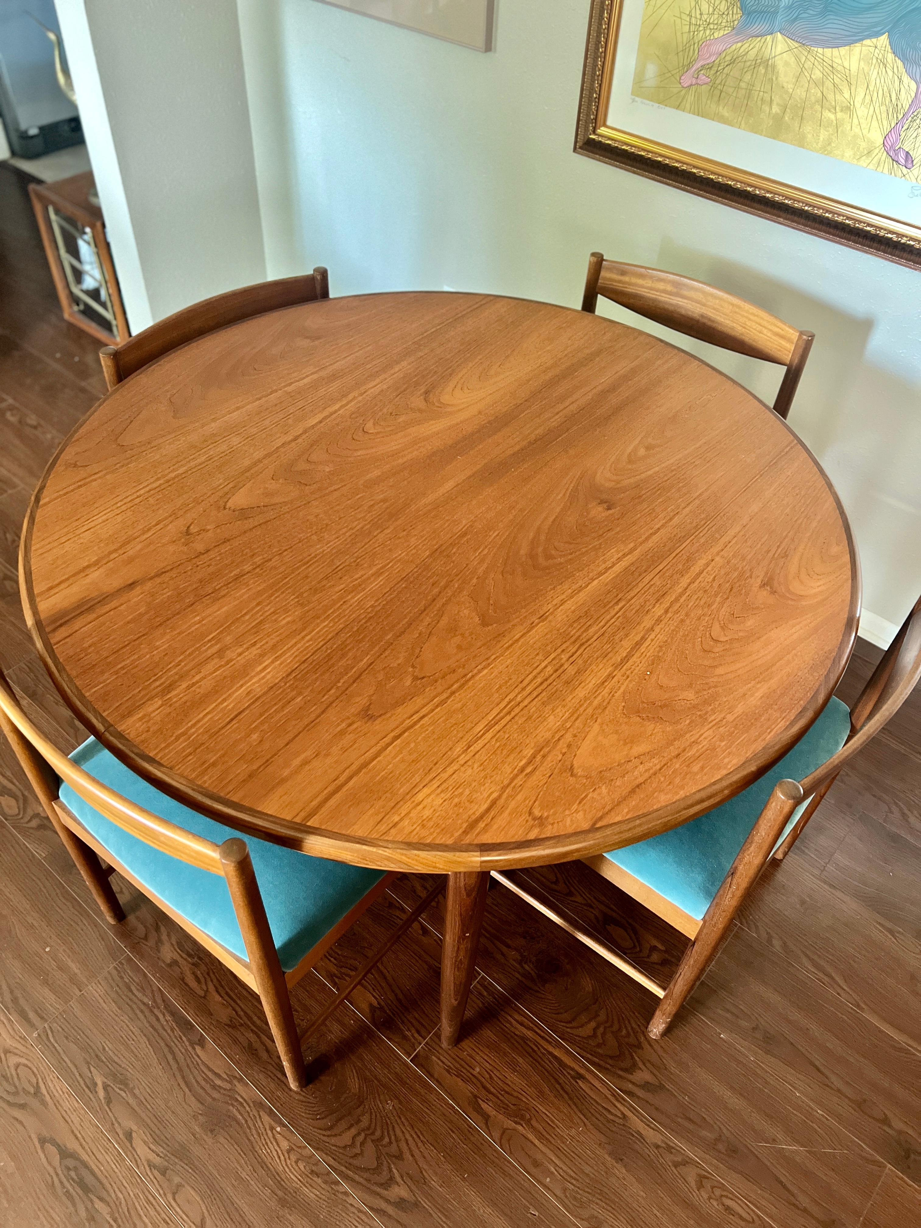 Mid-20th Century A MCM round teak dining table by G plan, with one 18