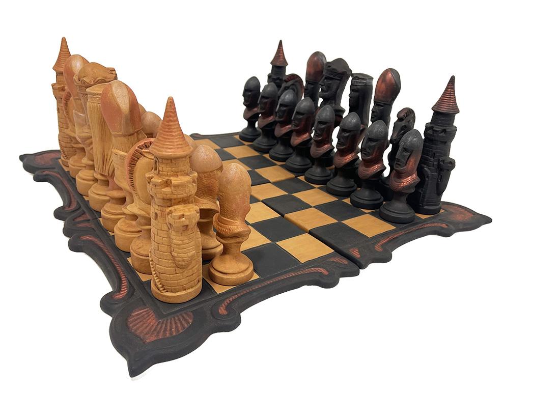 A medieval style chess set made in cast clay

A cast clay chess set in medieval style with 4 loose tiles. 
The 4 separate tiles form the chessboard, which are also cast from clay. 
The entire set consists of 2 x 16 figurative sculptures and 4 loose