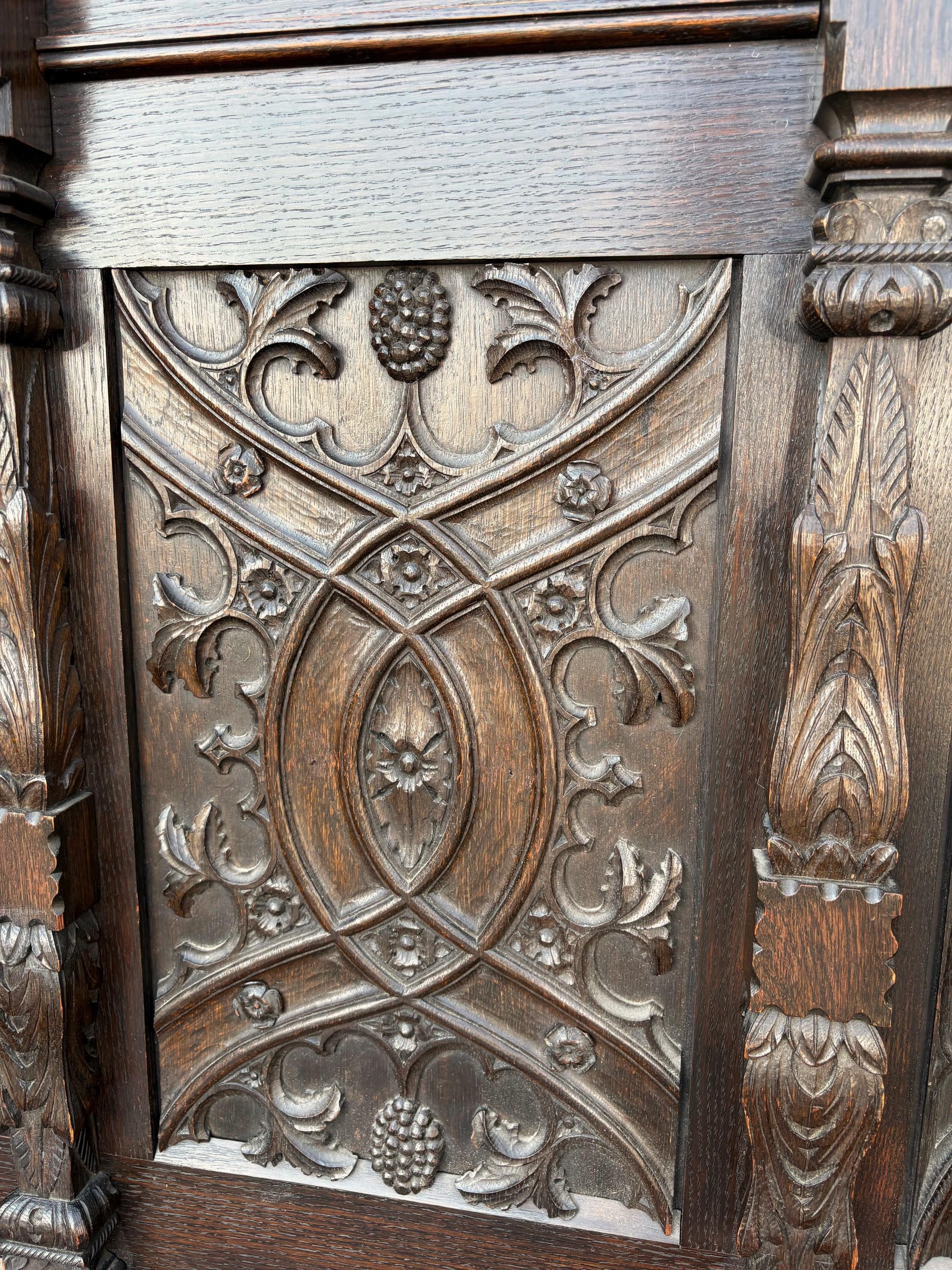 A Medieval Style Gothic Bench.      A Gothic Bench Seat with storage. Profusely carved in the Tudor Gothic style. Solid oak construction with iron strap hinges to the storage seat. First quarter last century. 