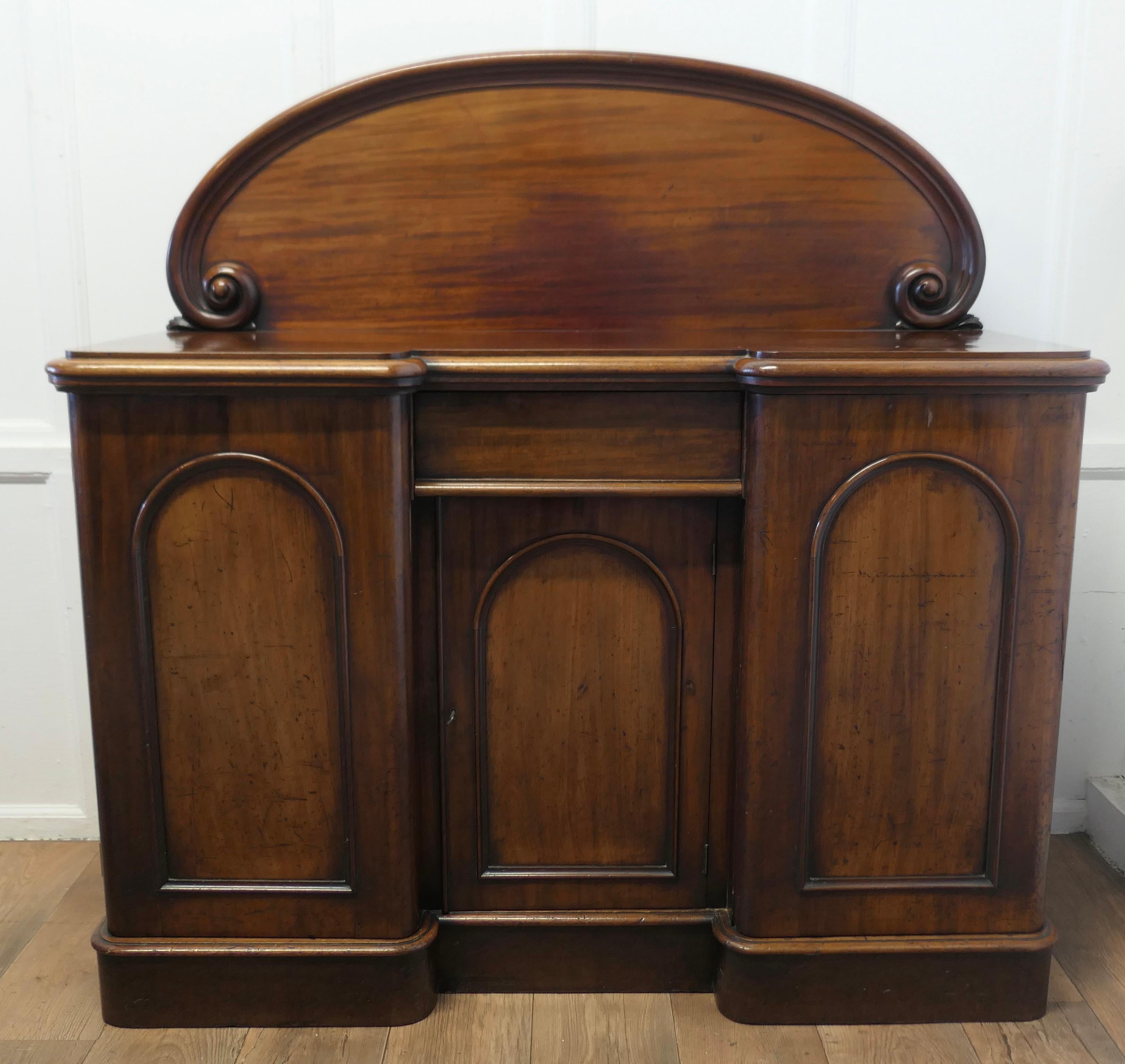 A Medium Size Victorian Sideboard or Chiffonier

The Sideboard has an arched back with carved scroll decoration and it is set on a deep plinth
The Chiffonier has a slight Break front shape with a moulded edge to the counter top, there are 3 arch