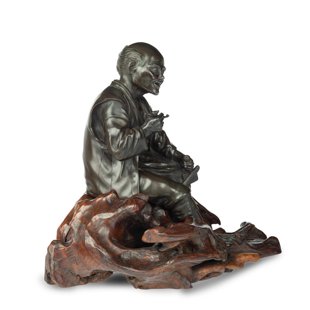 19th Century A Meiji period bronze of a seated man smoking For Sale