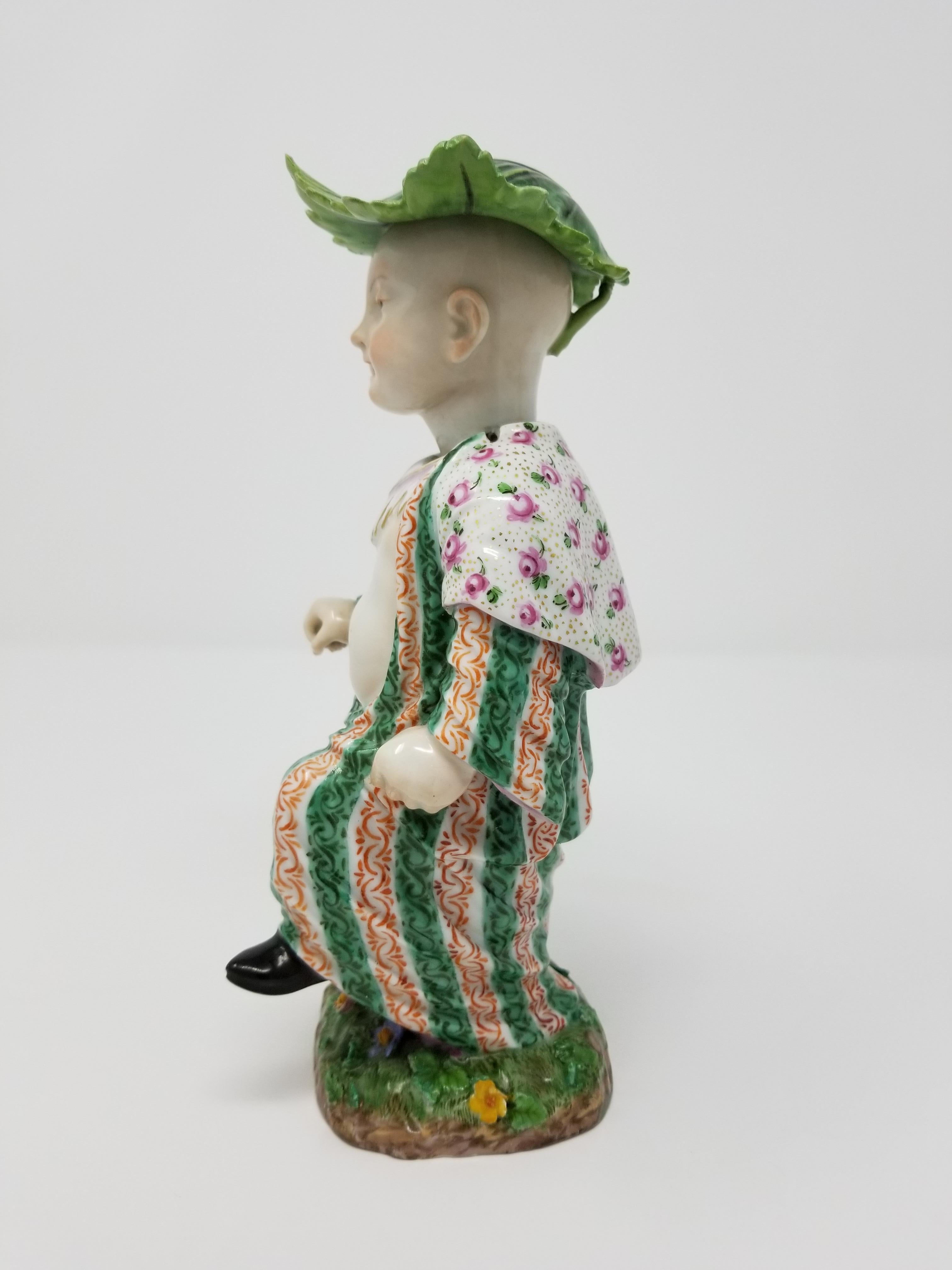 An exquisitely detailed 19th century Meissen nodding figure of a Chinese Boy. After the 18th century model by Johann Joachim Kändler, the dancing figure with his left foot raised, marching and wearing a cabbage leaf-shaped hat, Under-Glazed Blue