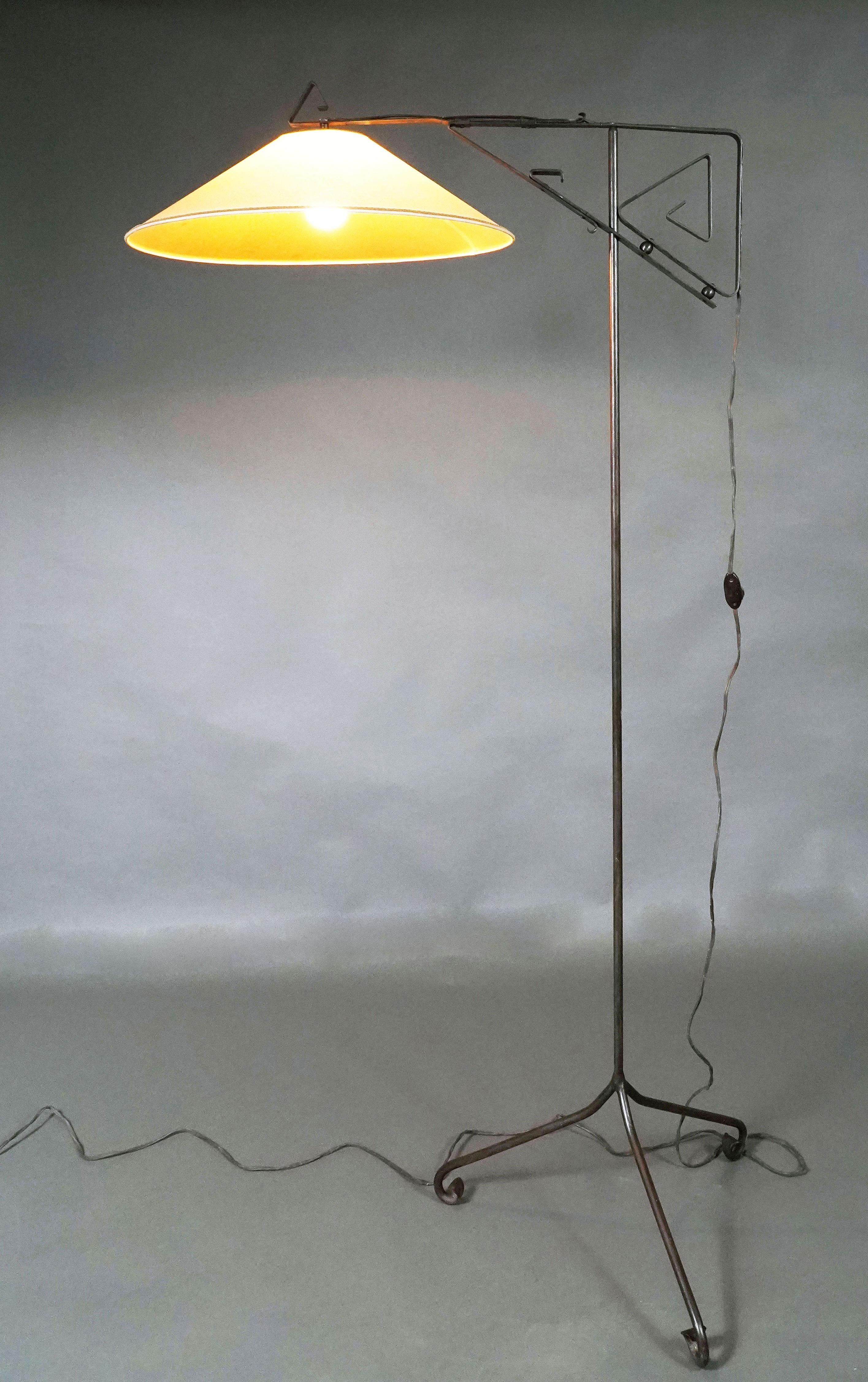 Width with Lampshade : 86,4 cm 
Diameter of the Lampshade : 54,5 cm
Dimensions of the tripod part : 54,5 cm for each side

Floor lamp in black patinated metal, the arm perpendicular to the shaft ending in a coiled motif.

European Artistic Context