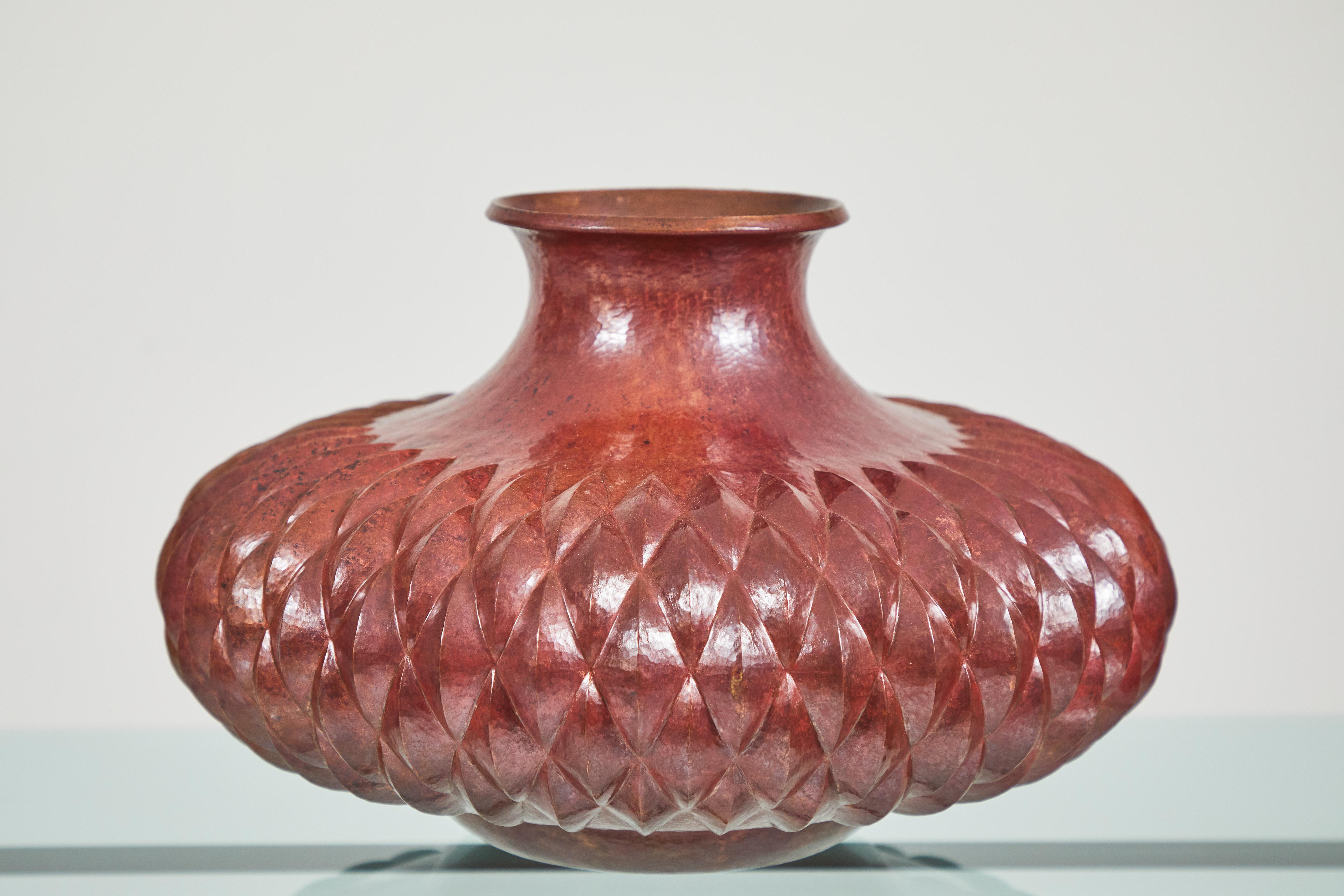 Made by Ignacio Punzo Ángel, this copper vase has been hand burnished and chased in a multiple diamond shaped pattern. The Punzo family is well known for their copper and silver craftsmanship. Located in Santa Clara Del Cobre in Mexico, the mastery
