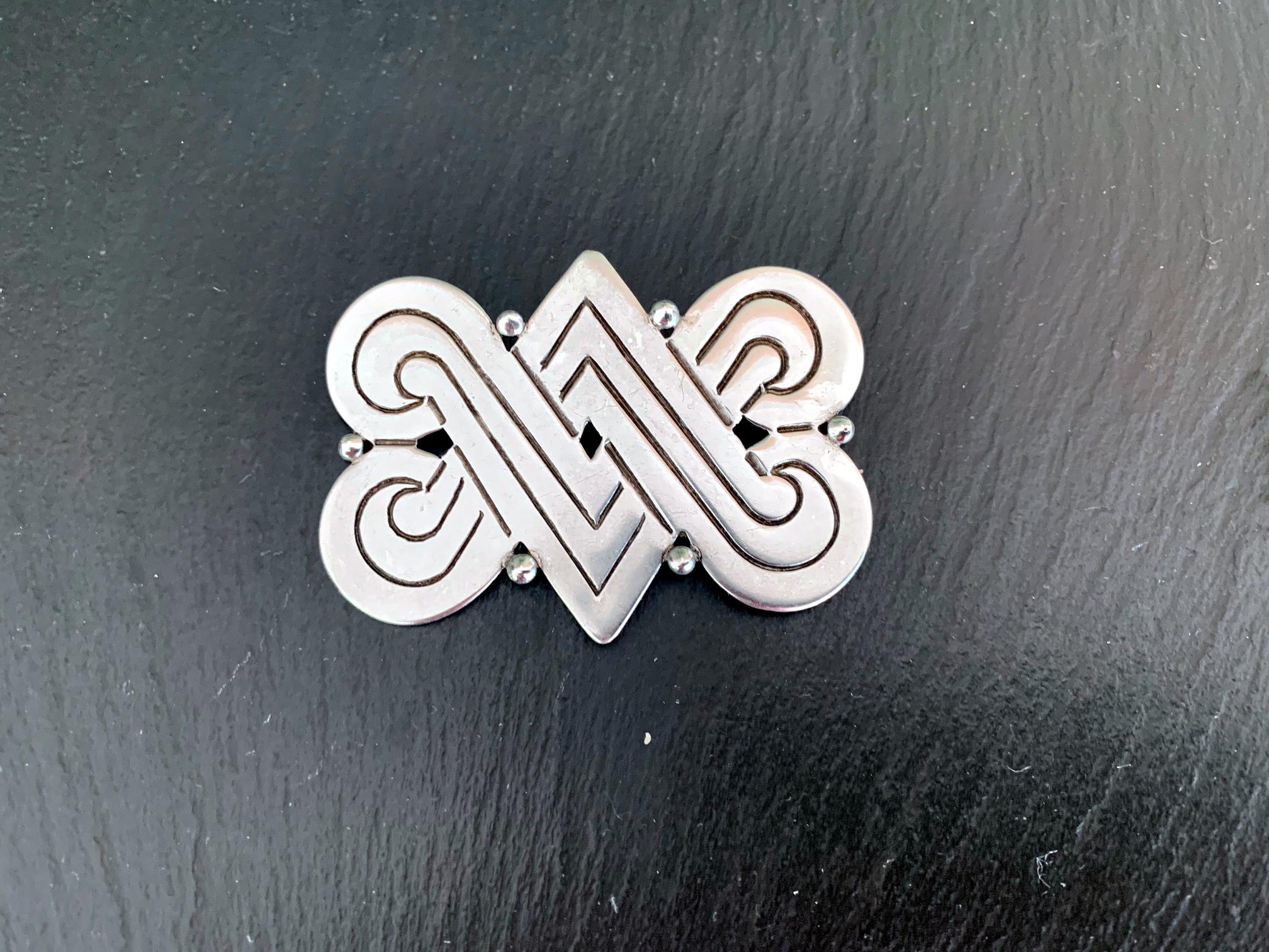 A vintage sterling silver brooch from the workshop of Hector Aguilar (1905-1986) in Taxco, Mexico, circa 1940s. The double V design featured on this brooch was inspired by indigenous Mexican symbolism for fertility. Hallmarked on the back as