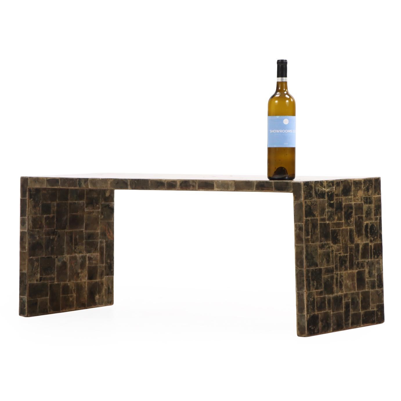 The rectangular top finely inlaid with a shimmering marquetry surface of natural mica, displaying subtle black, brown, and bronze tonal variations. The restrained form and luxurious material capture the quiet sophistication and refined minimalism