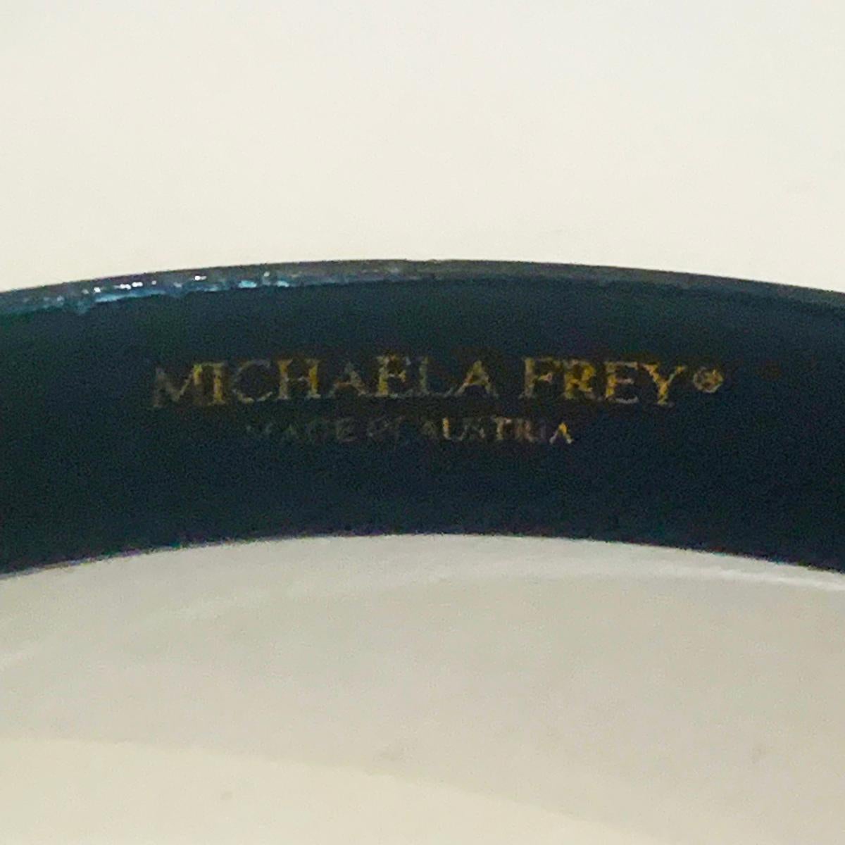 Early Original Michaela Frey Enamel Bangle, in pink and white Floral tones and Design. Excellent condition for age, no missing enamel. Extremely fine attention to detail. Dimensions are approx..: Wrist size 63mm internal x 9mm wide x 1mm thick.