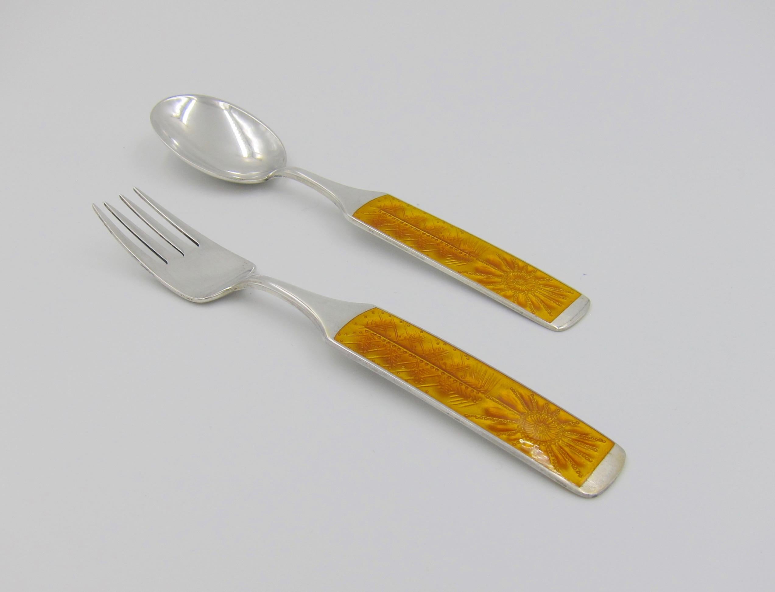 A Danish sterling silver and enamel Christmas fork and spoon set from Anton Michelsen of Copenhagen, Denmark. Artist and sculptor Paul René Gauguin (1911-1976) created this design called 