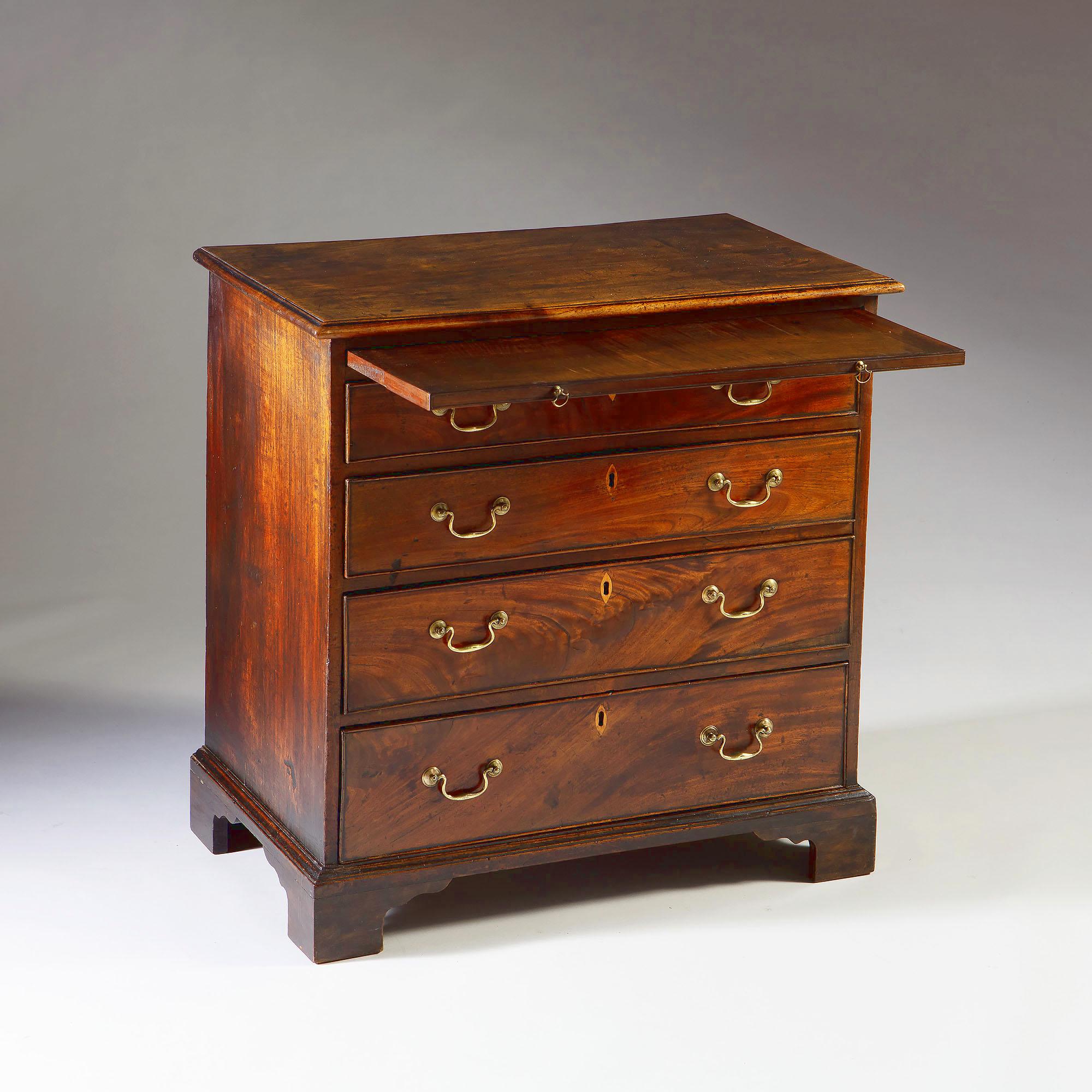 A fine mid-18th century mahogany chest of drawers with fine figuring, with four drawers to the front, with brushing slide to the frieze, all supported on bracket feet.