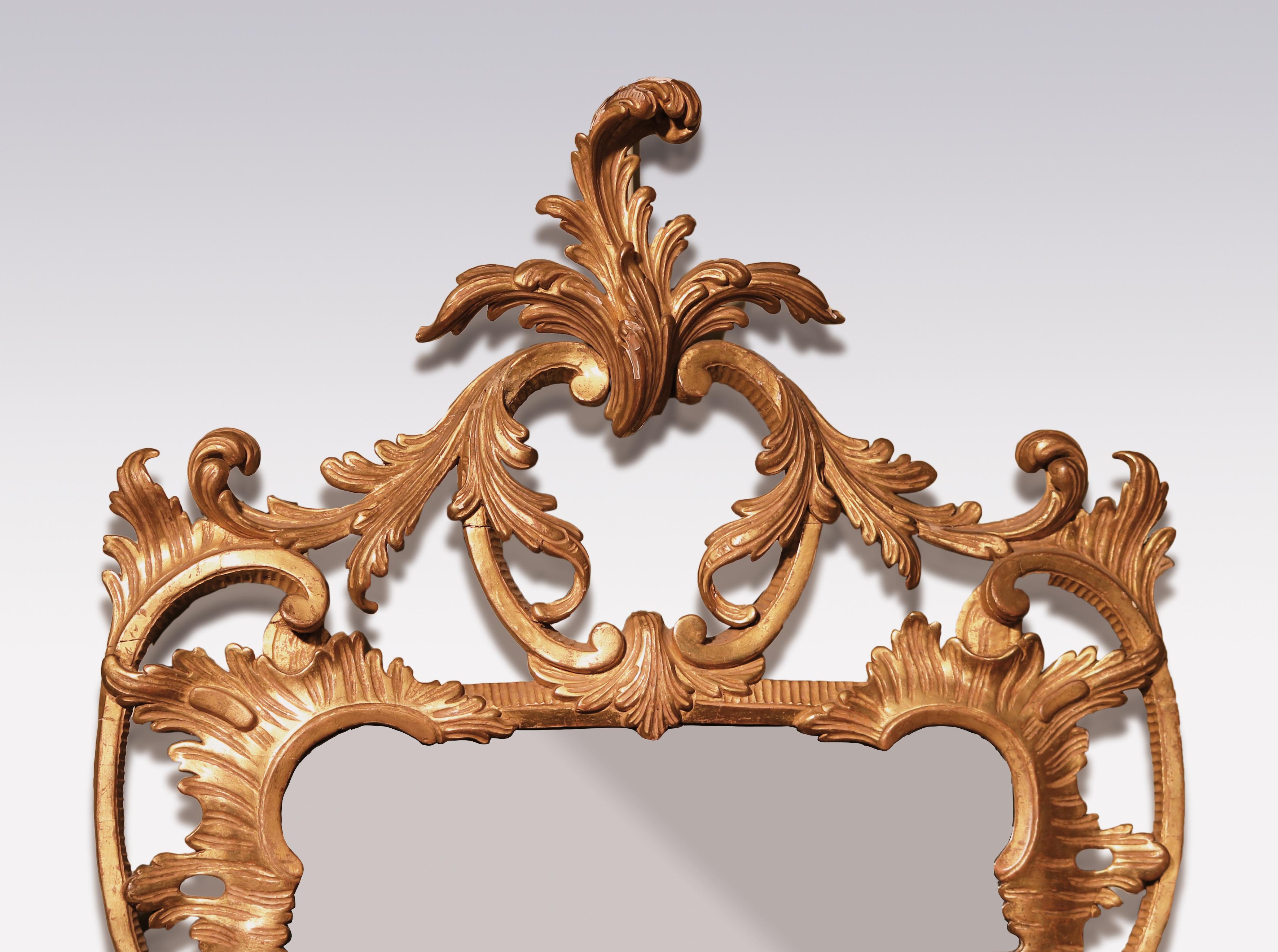 A fine quality mid 18th century Chippendale period carved giltwood Mirror, having leaf scrolled cartouche above shaped frame flanked by fruit and flower borders with pierced “C” scroll below.

