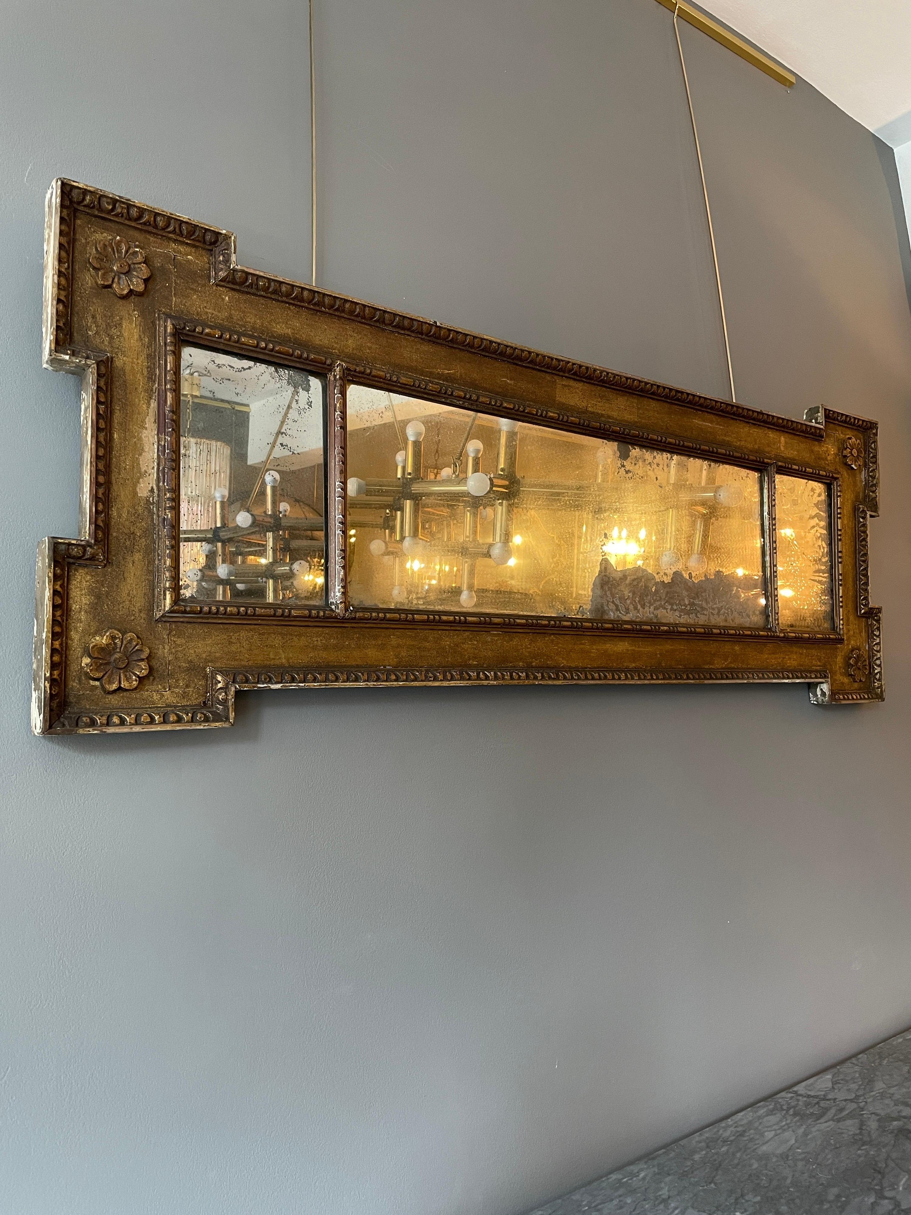 A George II mirror in original and untouched condition, in the manner of William Kent. The frame with egg and dart border, rosettes to corners and three piece original distressed mercury mirror with beaded frame. 

English, Circa 1750.