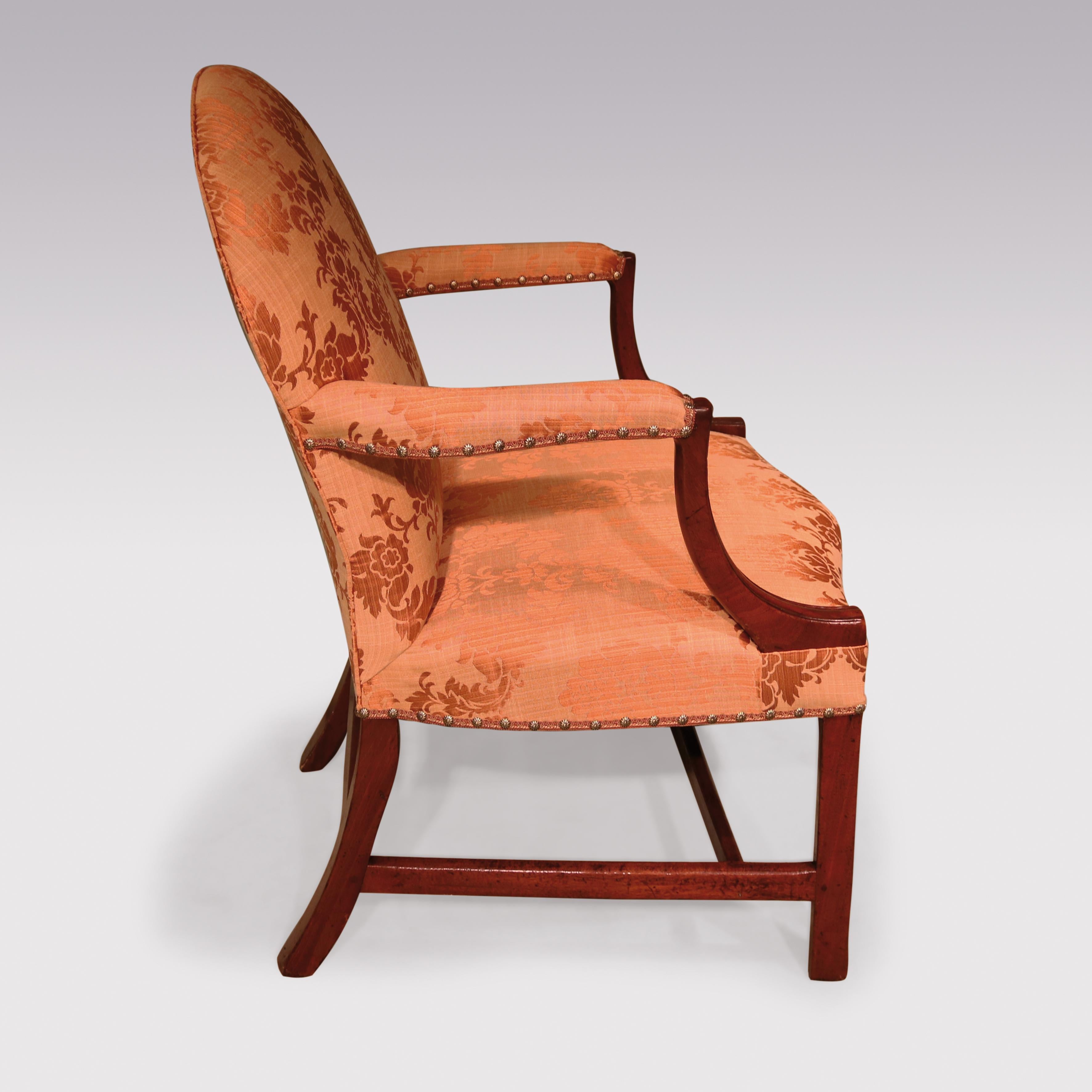 A mid 18th century George III period mahogany Gainsborough armchair, having rounded top above set-back shaped arms with moulded supports, raised on moulded square legs with square stretchers.