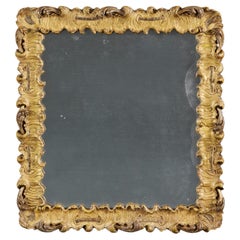 A mid 18th century rocaille giltwood mirror 