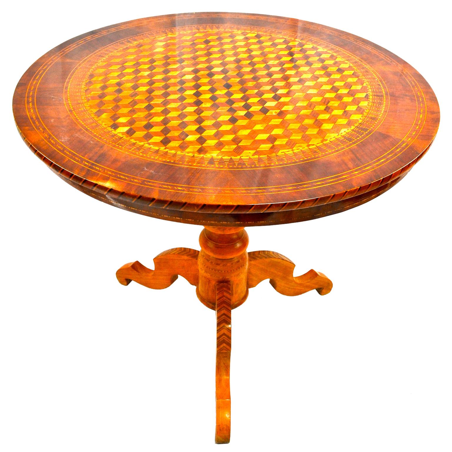The circular top with striking geometric inlay in three different woods creating an almost optical illusion of depth. The top rests on a turned inlaid column terminating in three splayed legs, also inlaid. The city of Sorrento on the Amalfi Coast in