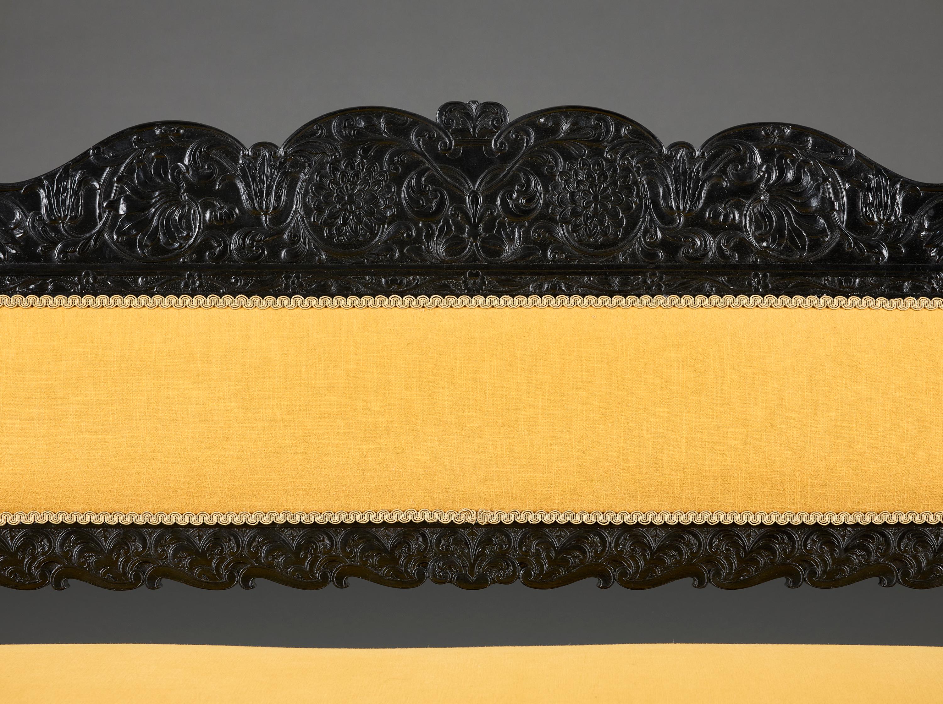 A Mid-19th Century Anglo-Indian Carved Ebonised Sofa (Anglo-indisch) im Angebot